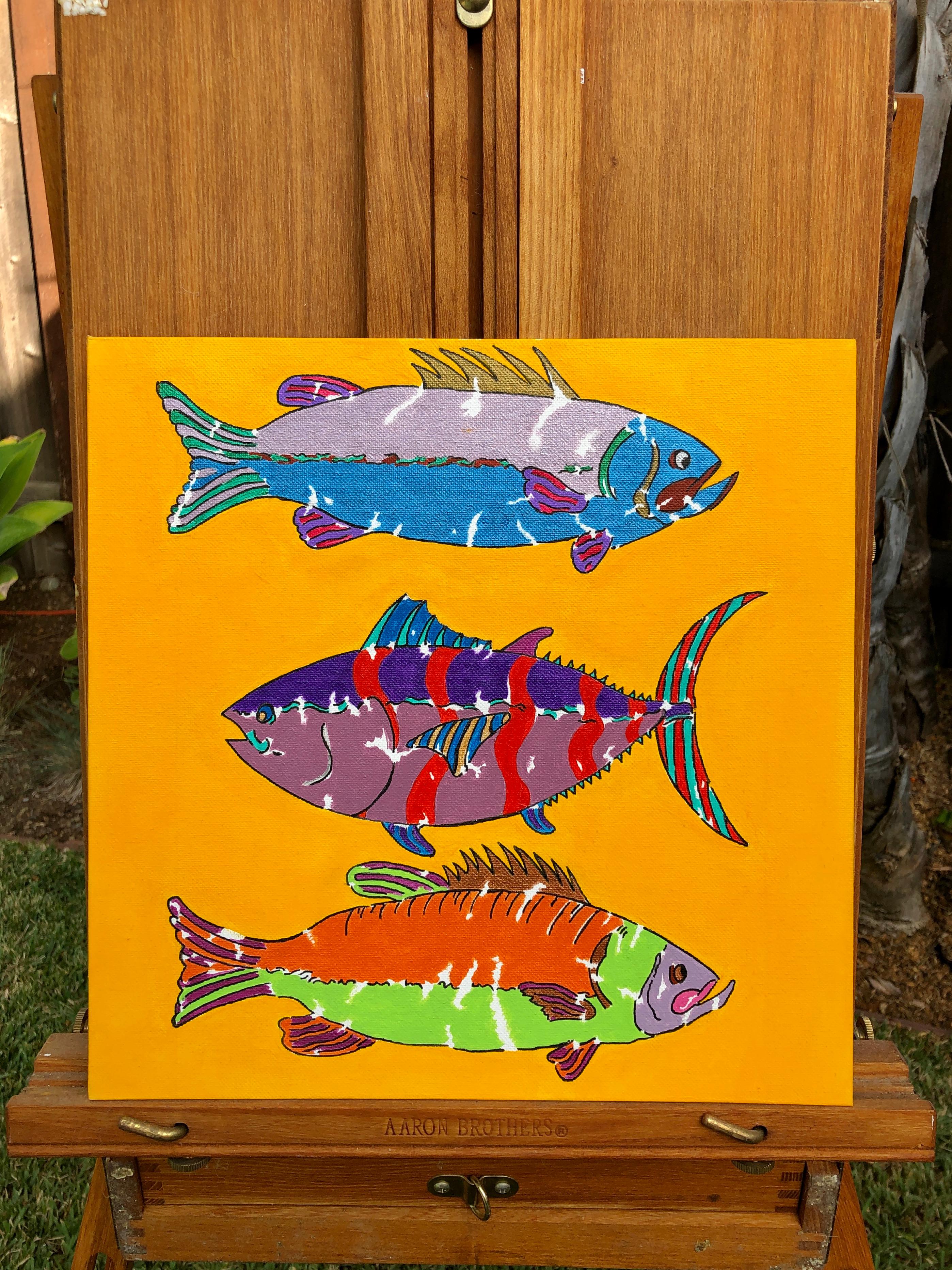 <p>Artist Comments<br />Three colorful fihes swim against a bright orange background. Artist John McCabe originally created the piece to accompany the live recording of the band 
