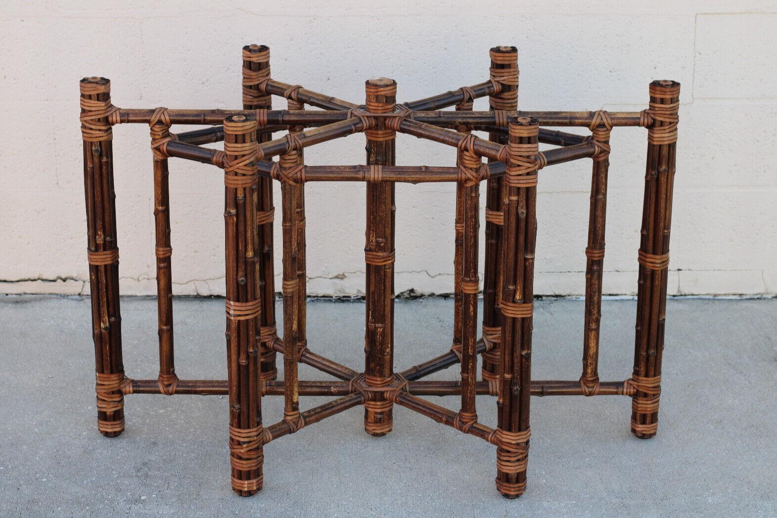 A natural brownish-black bamboo dining table base with six legs designed by John McGuire. This beautiful and rare circa 1970s table base, crafted entirely by hand, is constructed of iron pipe, bamboo, and rawhide. Bamboo lengths have been carefully