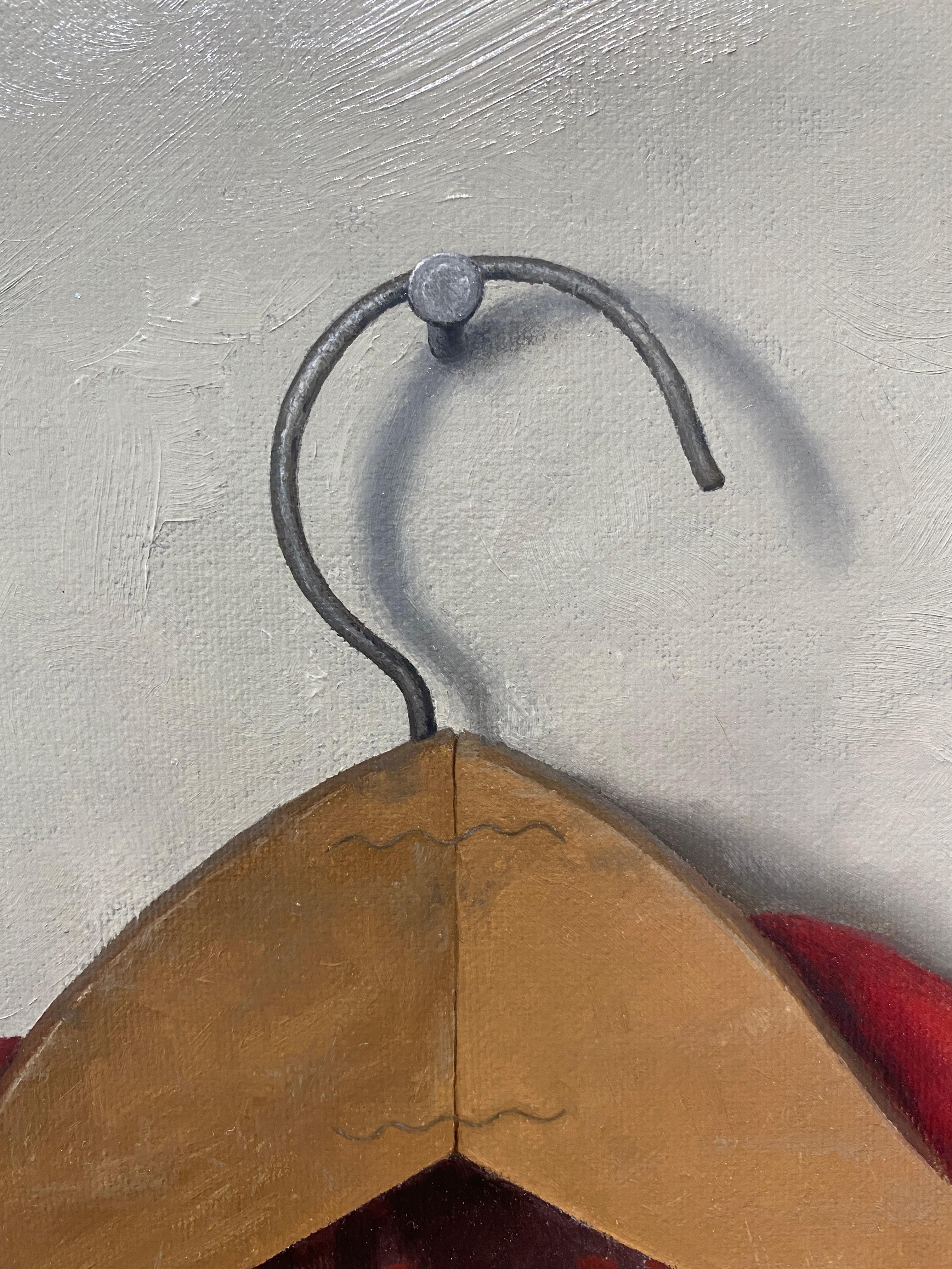 An oil painting of a vintage flannel zip-up. A classic red tartan plaid jacket, on a wooden hanger, hanging from a single nail, against a grey backdrop. Brushstrokes can be seen in the gray of the background, but are harder to make out on the