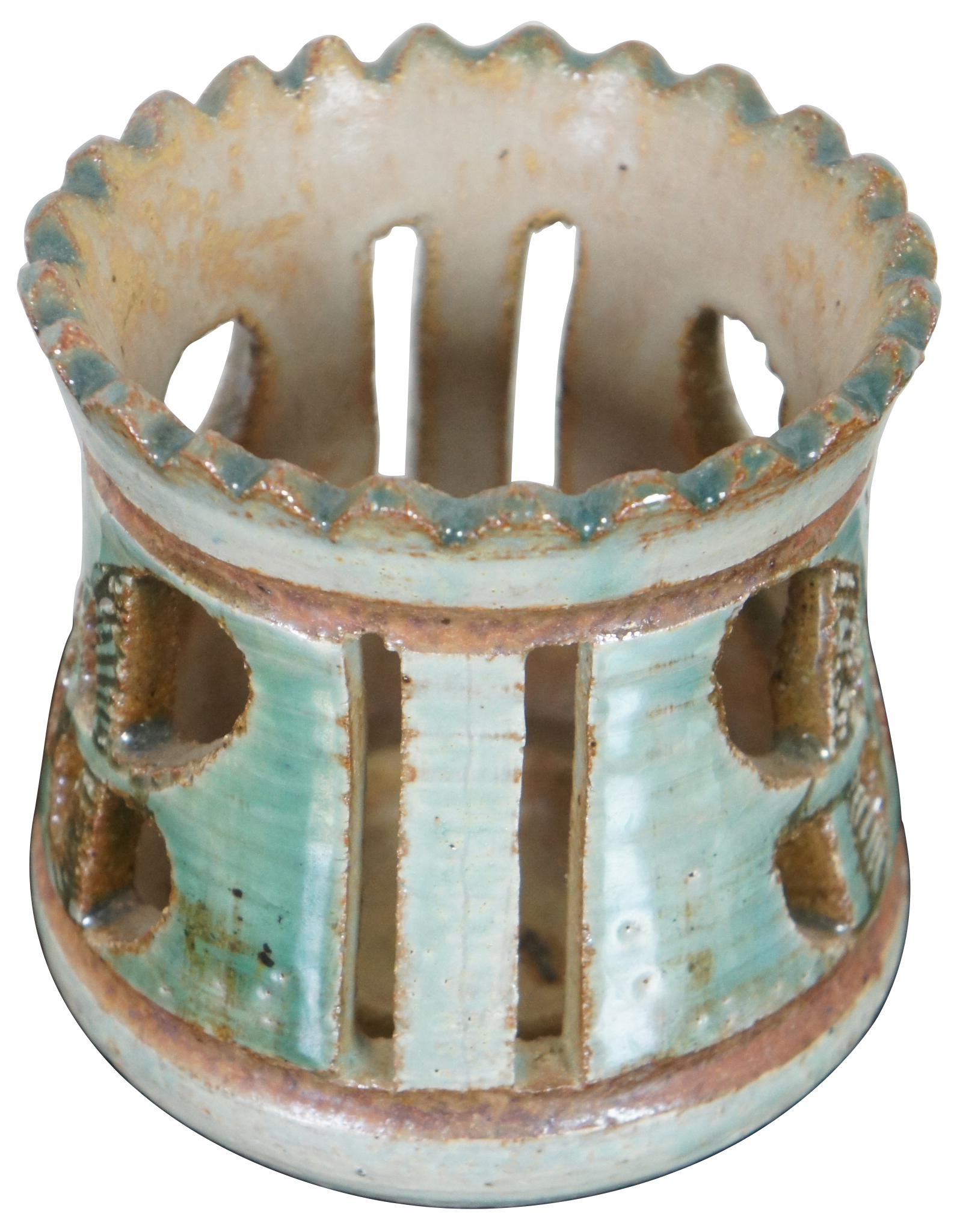 Vintage handmade ceramic candleholder by John Nartker, featuring a pierced butterfly design and a light turquoise glaze with brown details. Signed on vase. BIO: John Nartker (1930-1988) is a multi-media artist whose specialties are painting,