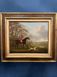 English 19th century Fox hunter with hounds, hunter and rider in a landscape