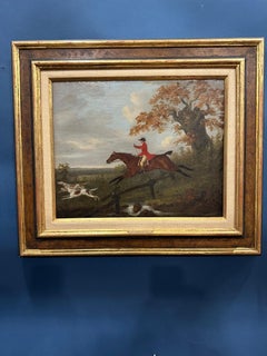English 19th century Fox hunter with hounds, hunter and rider in a landscape
