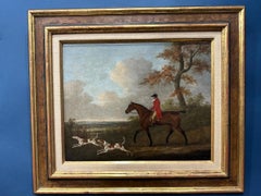 English 19th century Fox hunter with hounds, hunter and rider in a landscape