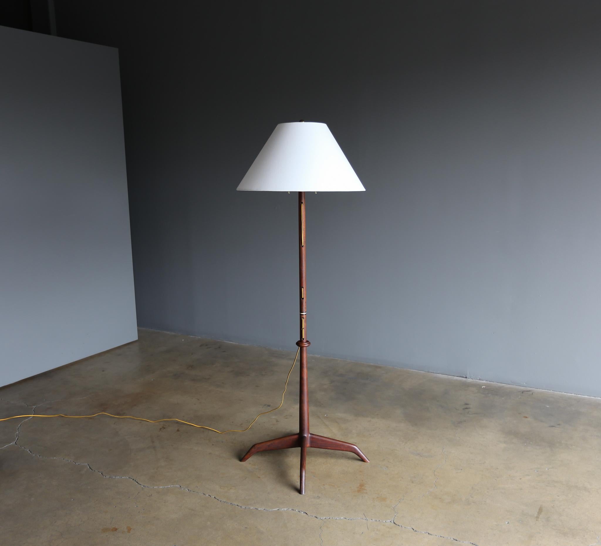 Handcrafted walnut floor lamp by California Craftsman John Nyquist woodworker, circa 1970. This piece is signed.