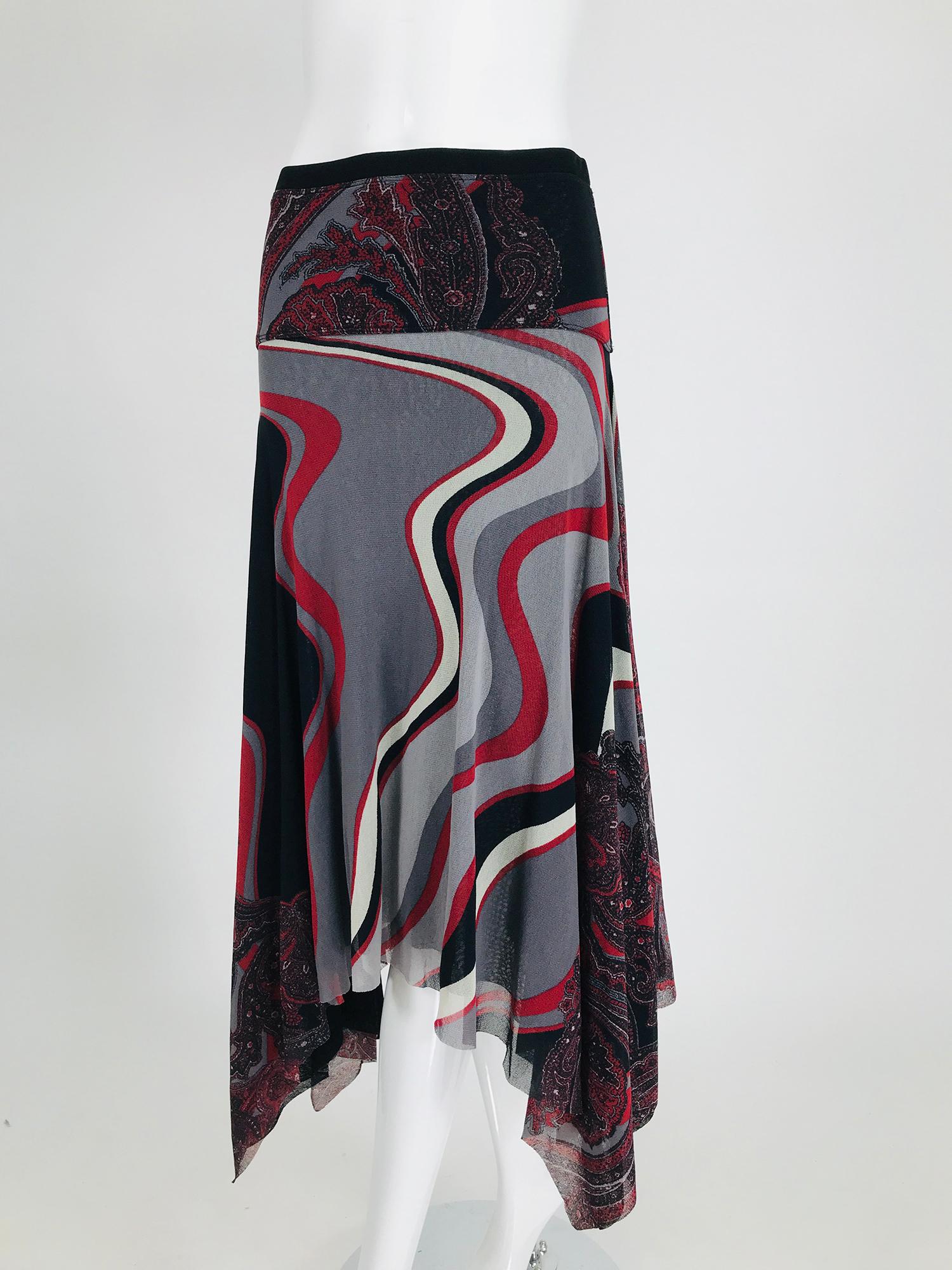  John Paul Gaultier Soleil printed mesh asymmetrical skirt. Pull on skirt is lined in black mesh. The hemline is irregular. The print is a paisley at the hip and swirls of greys & reds from the hip to the hem. Fits a size small.
     In excellent