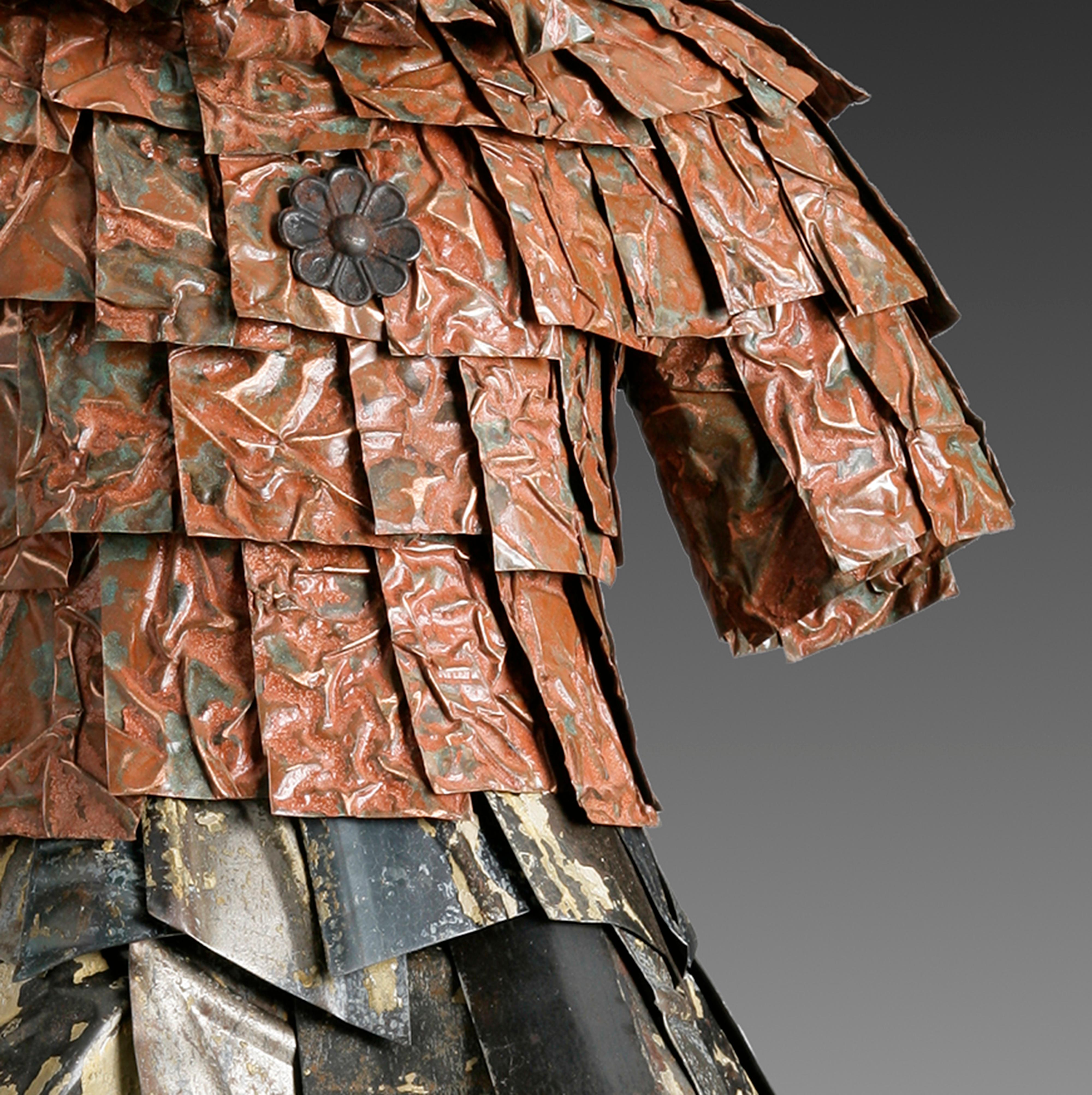 The sculpture is an artistic take of the 1960's shirtwaist dress incorporating  enamel embossed license plates, steel bottle cap bodice. 27” tall - Vintage Ceiling Tin, Rust Patina Textured Copper