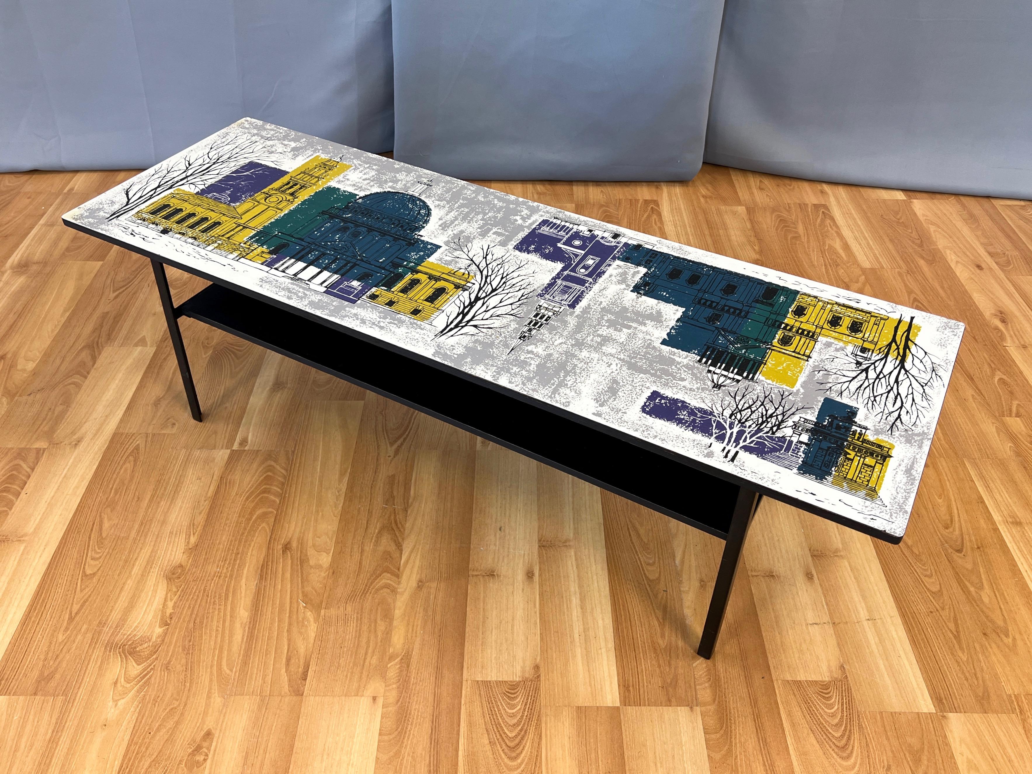A very charming circa 1960 two-tier low coffee table featuring an illustrated London skyline top by John Piper, and produced by Myer for Conran and Heal’s.

White formica top serves as an expansive canvas for important UK painter, printmaker, and