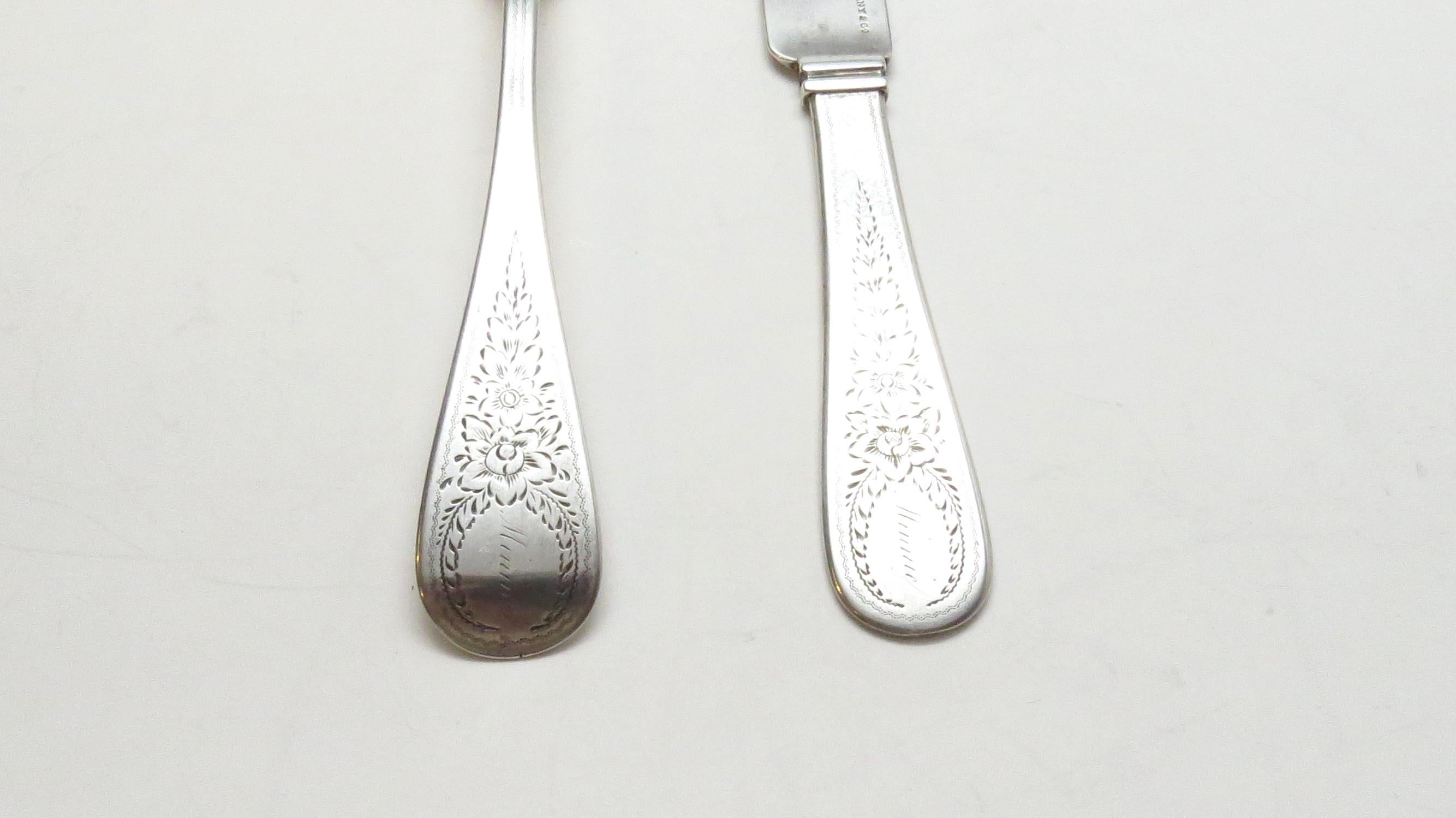 John Polhamus for Tiffany & Co. Sterling silver spoon and knife. 
Marked: TIFFANY & CO., J*P, STERLING. 
Engraved: Minnie. 
Flat solid knife: 7 1/2