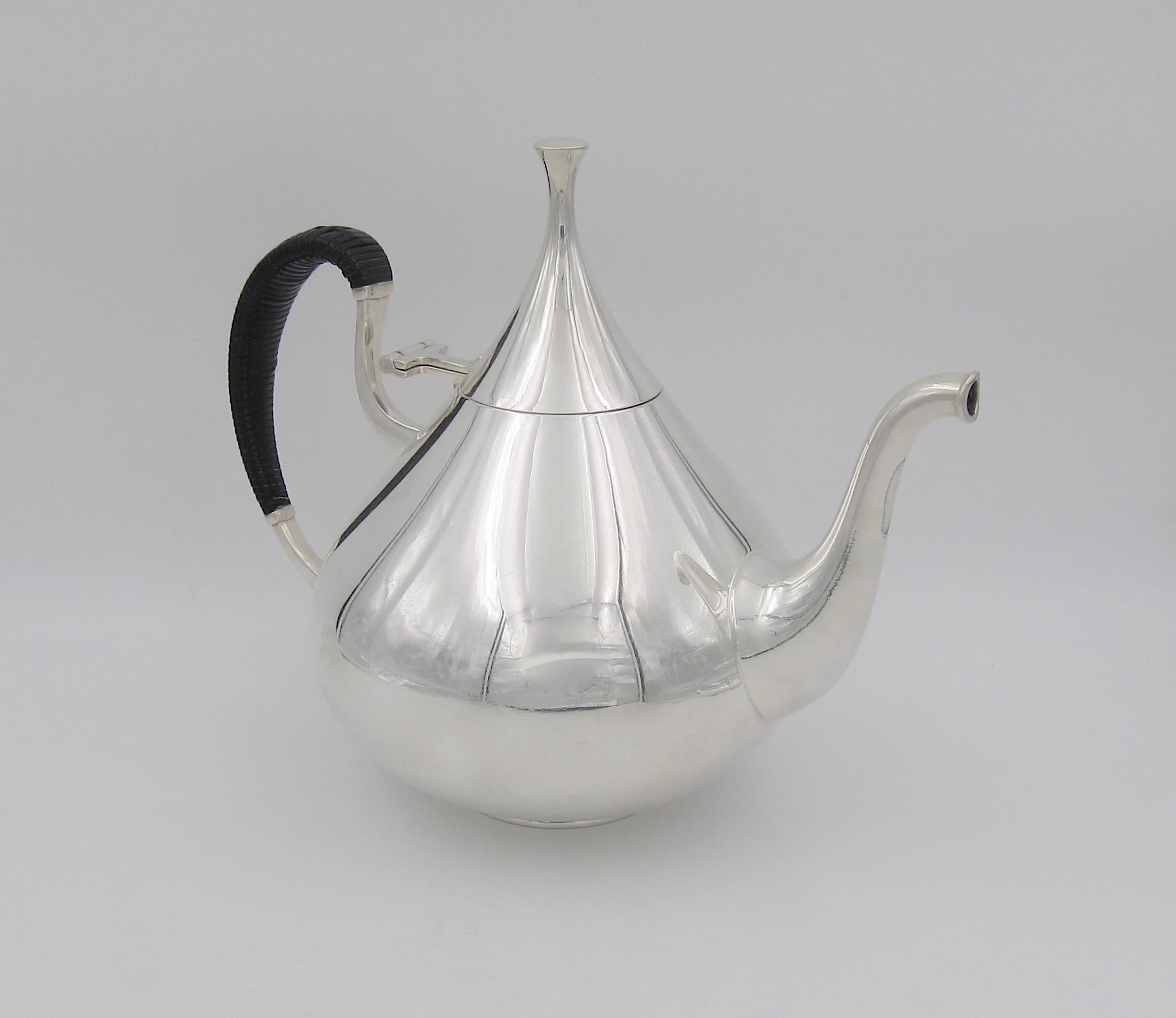An iconic Mid-Century Modern American coffee pot designed by master silversmith John Prip (1922-2009) for Reed & Barton of Taunton, Massachusetts in 1961. The 