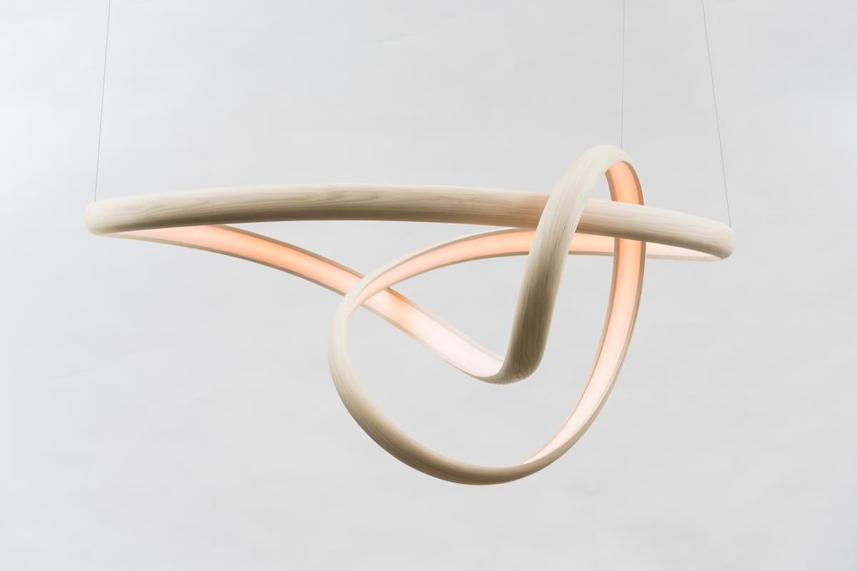 Procario’s sculptural lighting is composed of micro-laminated wood fused with LEDs. With a rough sketch in his mind, Procario freeform bends the wood into one of his signature undulating shapes. After months spent intentionally breaking wood,