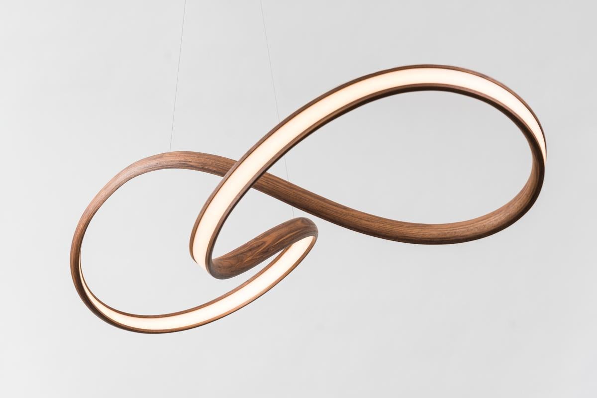 Procario’s sculptural lighting is composed of micro-laminated wood fused with LEDs. With a rough sketch in his mind, Procario freeform bends the wood into one of his signature undulating shapes. After months spent intentionally breaking wood—whether