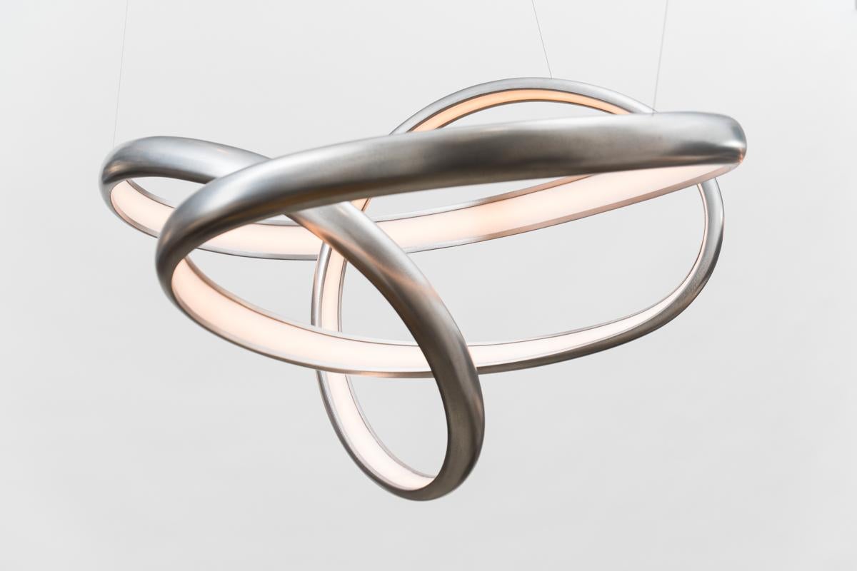 Procario’s sculptural lighting is composed of micro-laminated wood fused with LEDs. With a rough sketch in his mind, Procario freeform bends the wood into one of his signature undulating shapes. After months spent intentionally breaking wood-whether