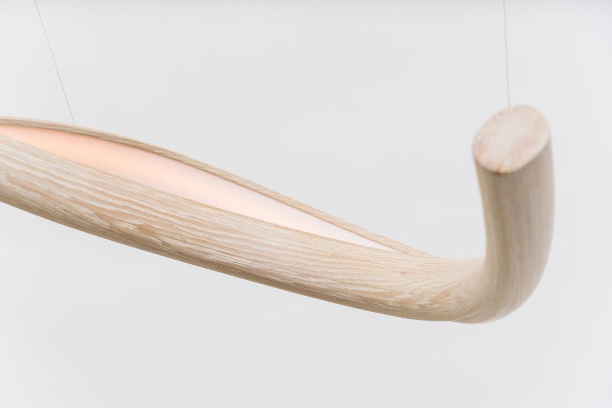 Procario’s sculptural lighting is composed of micro-laminated wood fused with LEDs. With a rough sketch in his mind, Procario freeform bends the wood into one of his signature undulating shapes. After months spent intentionally breaking wood,