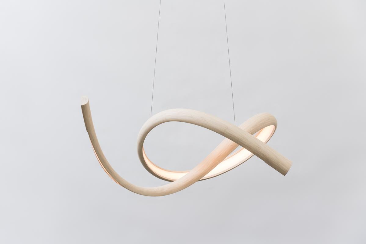 Procario’s sculptural lighting is composed of micro-laminated wood fused with LEDs. With a rough sketch in his mind, Procario freeform bends the wood into one of his signature undulating shapes. After months spent intentionally breaking wood—whether
