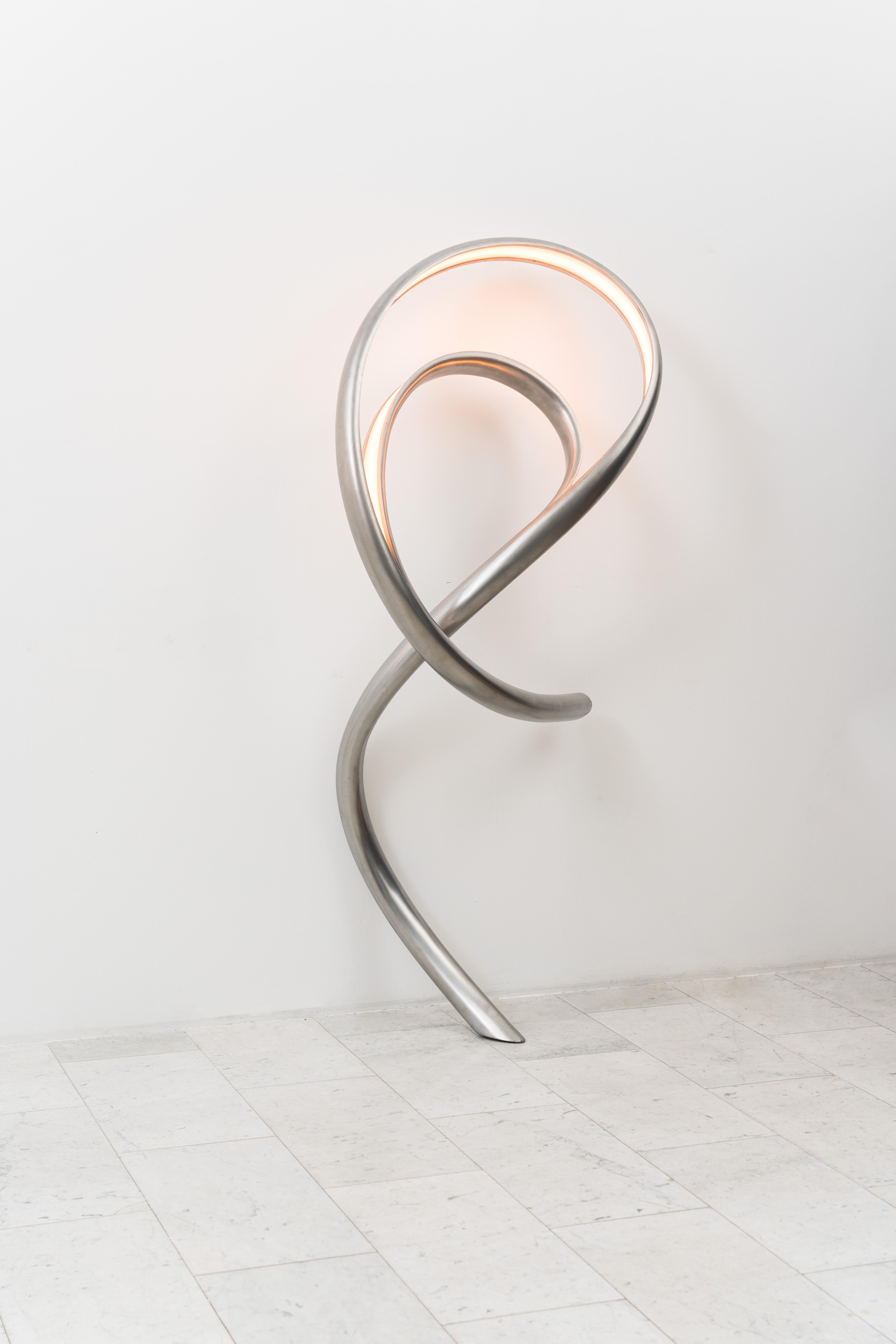 Procario’s sculptural lighting is composed of micro-laminated wood fused with LEDs. With a rough sketch in his mind, Procario freeform bends the wood into one of his signature undulating shapes. After months spent intentionally breaking wood,