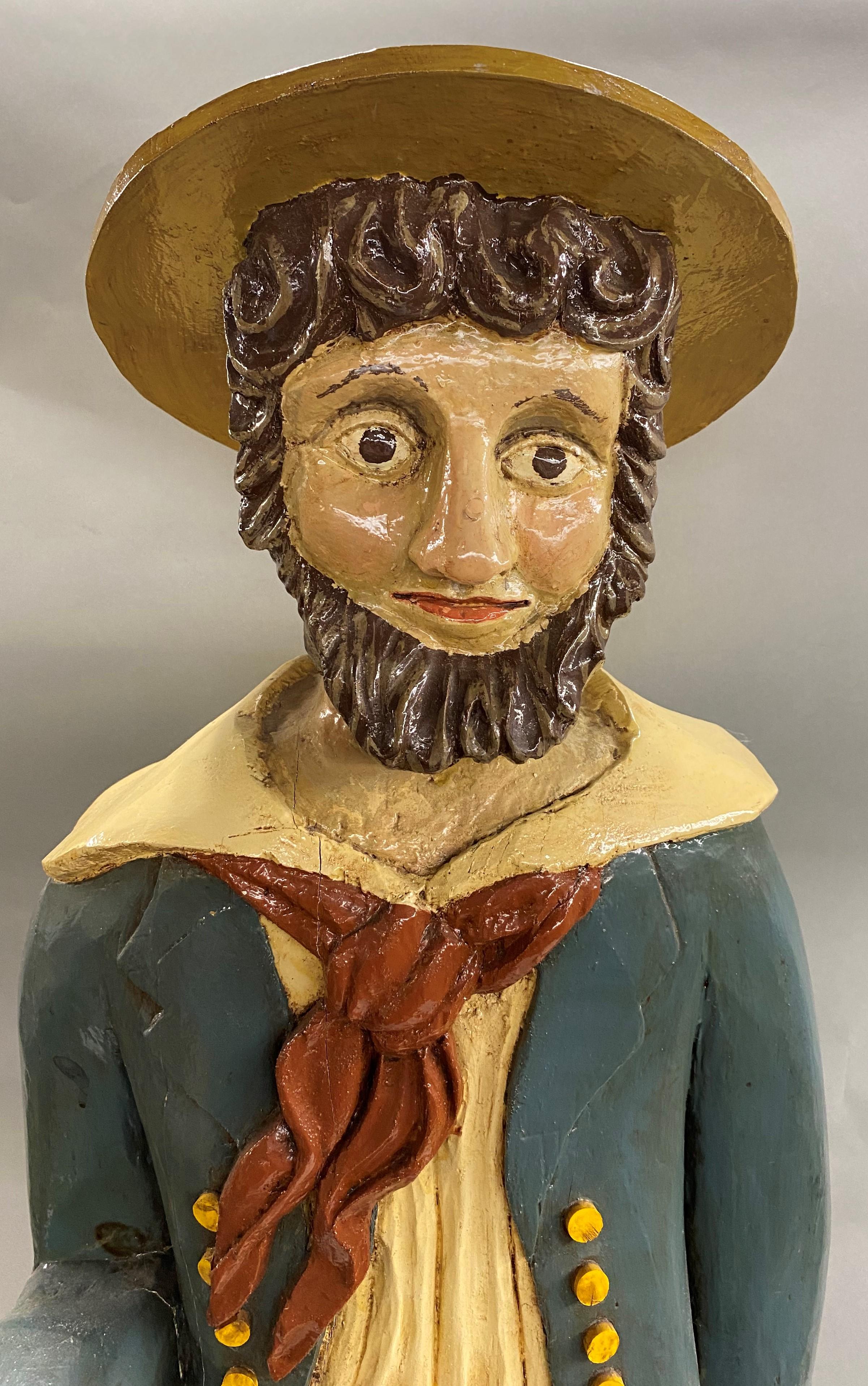 A fine 20th century American School hand carved folk art polychrome ship’s captain with beard and hat on wooden base, monogrammed on base “JRW 85”. Acquired with several other carved figures with full artist name shown on base. Very good overall