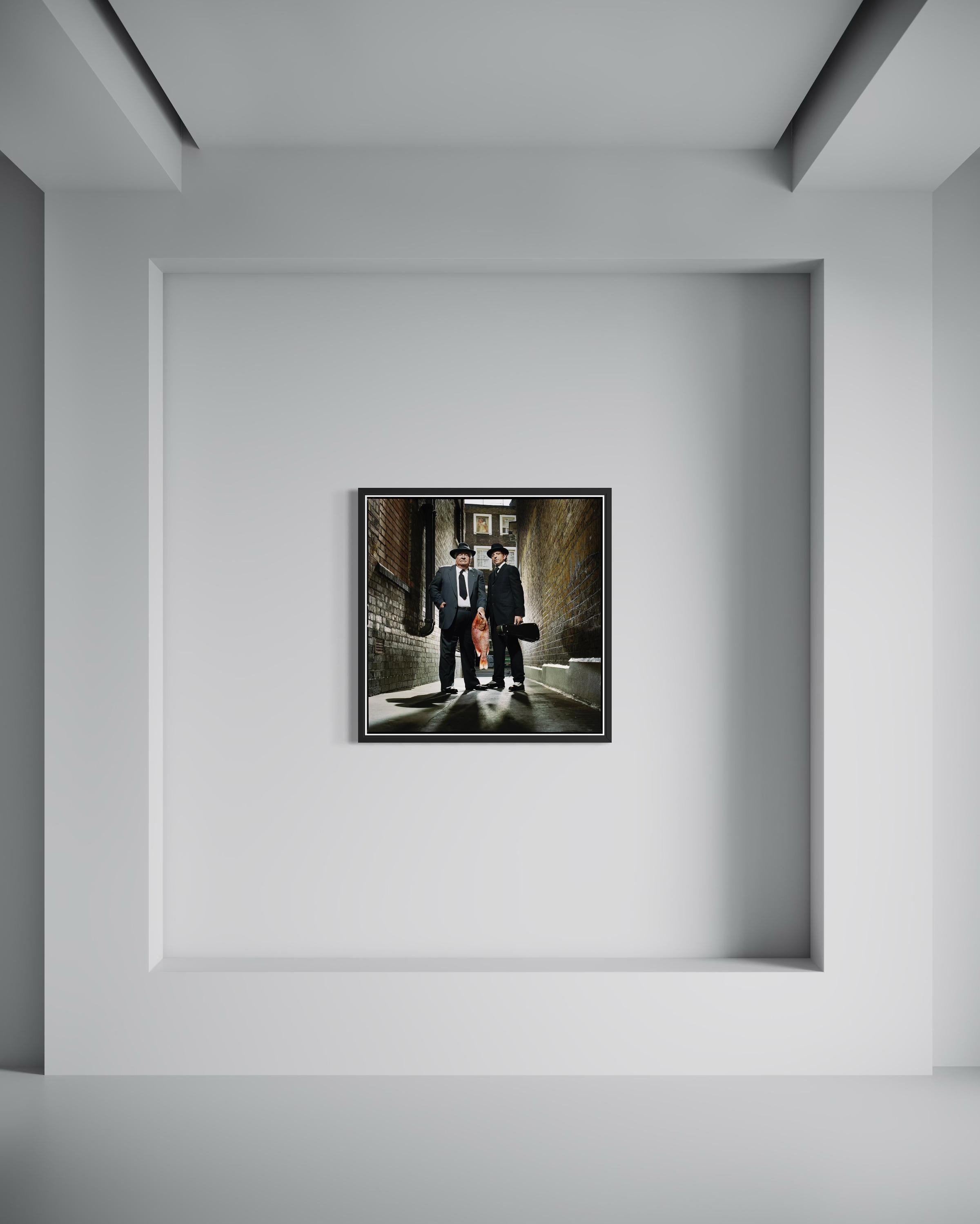 Chefs: Carluccio and Locatelli with Fish and Violin, England, Large Photograph - Noir Color Photograph par John Reardon