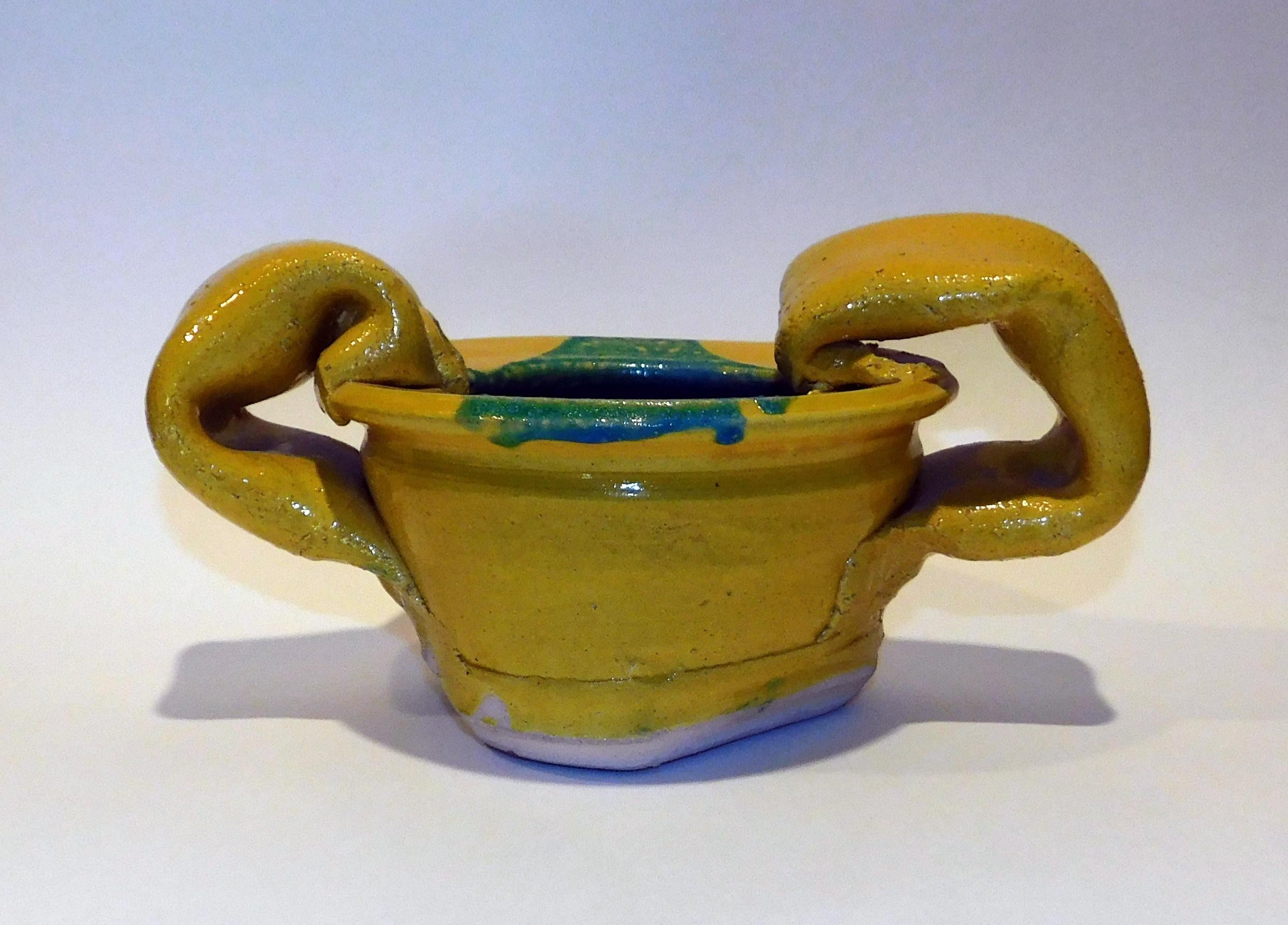 Wonderful Yellow pot with large handles by Canadian Art Potter John Reeve. 
Created circa 1970 this work measures 5 1/4