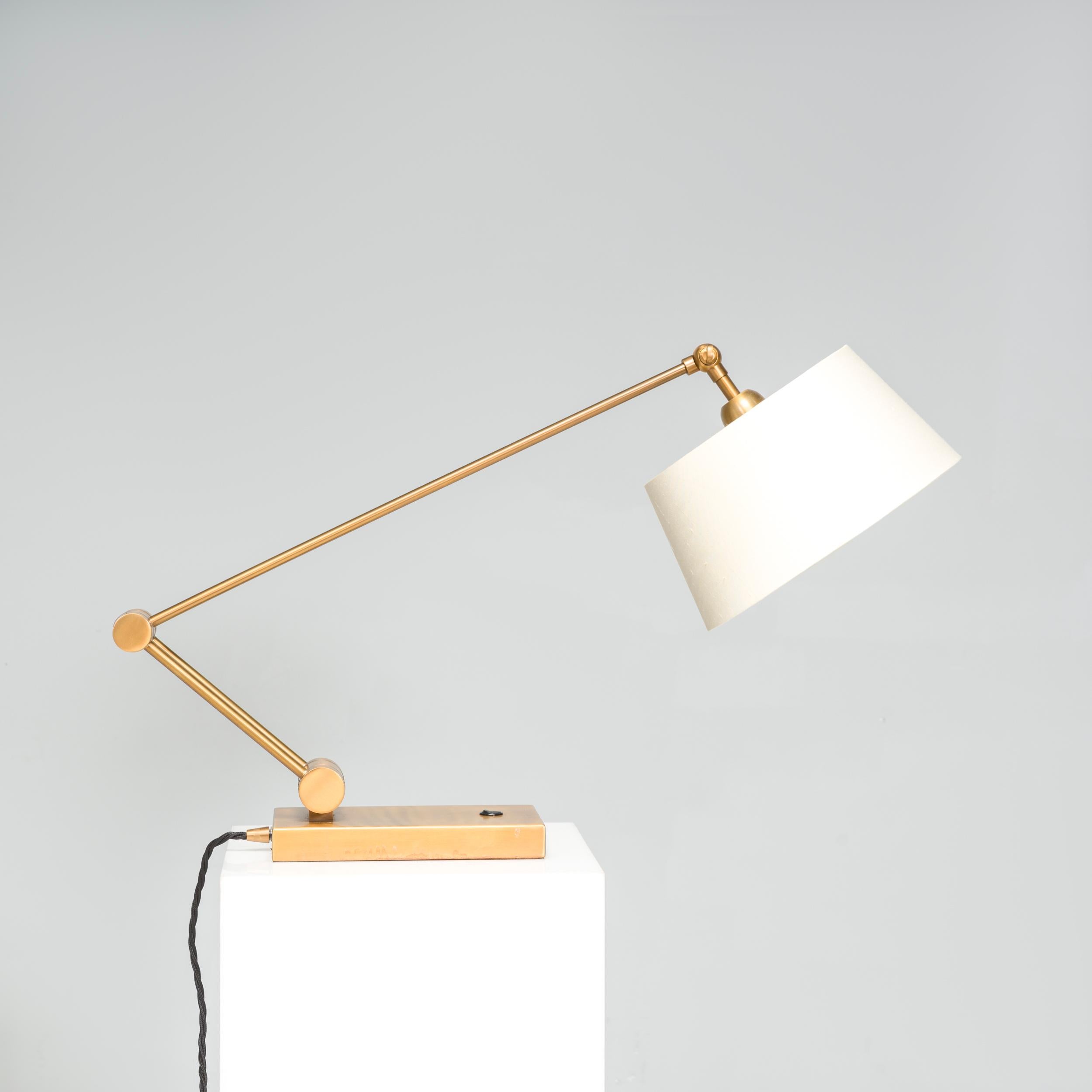 This brass desk lamp by Heathfield & Co has an impressive design that would elevate any living space or bedroom. The angular shape of its arm, punctuated by a rounded hinge, is counterbalanced by the rounded cream lampshade. The desk lamp would