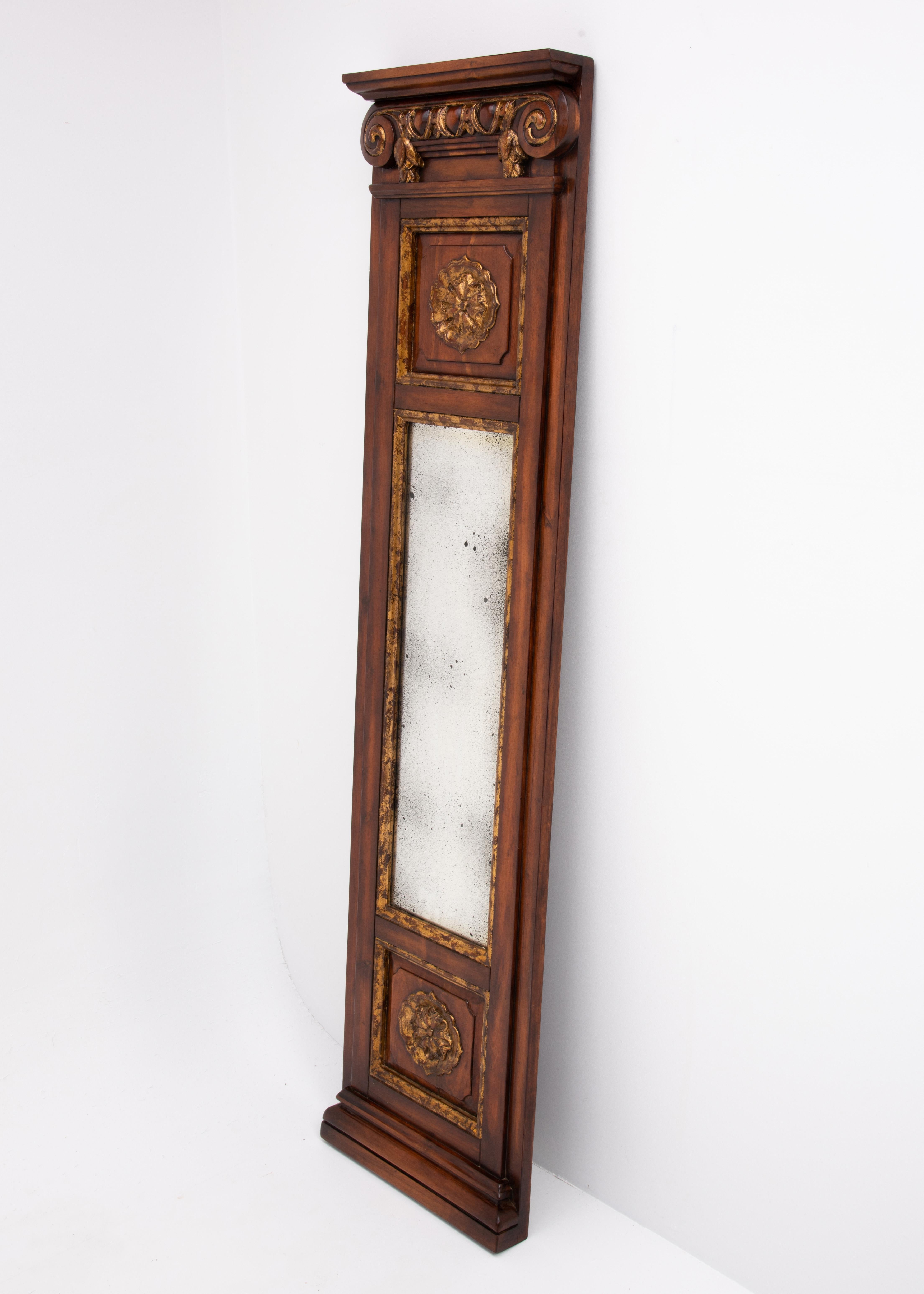 A versatile John Richard eglomisé floor, hall or wall mirror from the late 20th to early 21st century. The mirror features gilt carvings. It has factory brackets to hang but no wire.