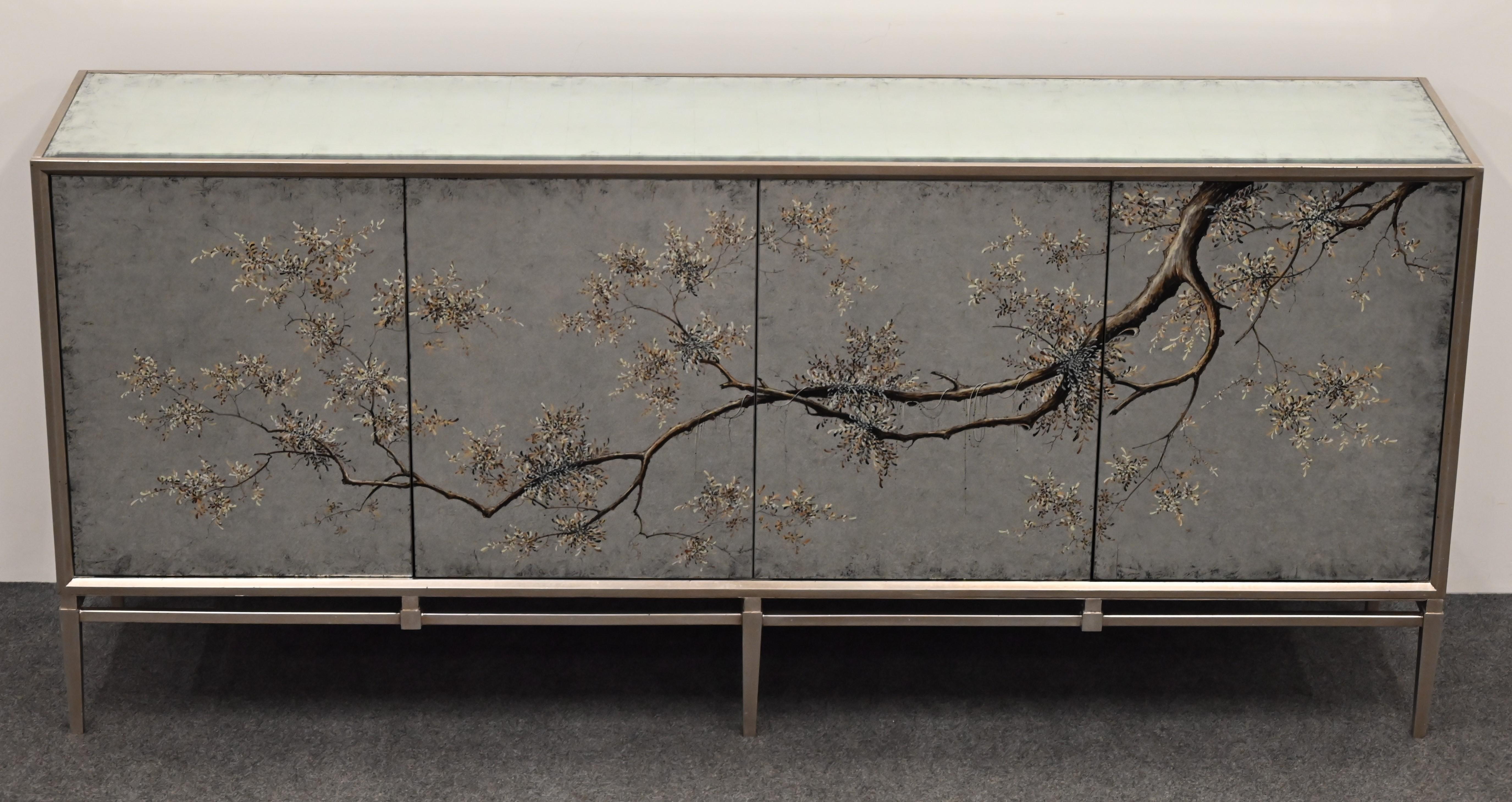 A beautiful contemporary credenza or sideboard by John Richards made of egliomese and mirror (reverse painted). This gorgeous piece was preowned and now available at a much-reduced price from the original price of $9200. It is in beautiful original
