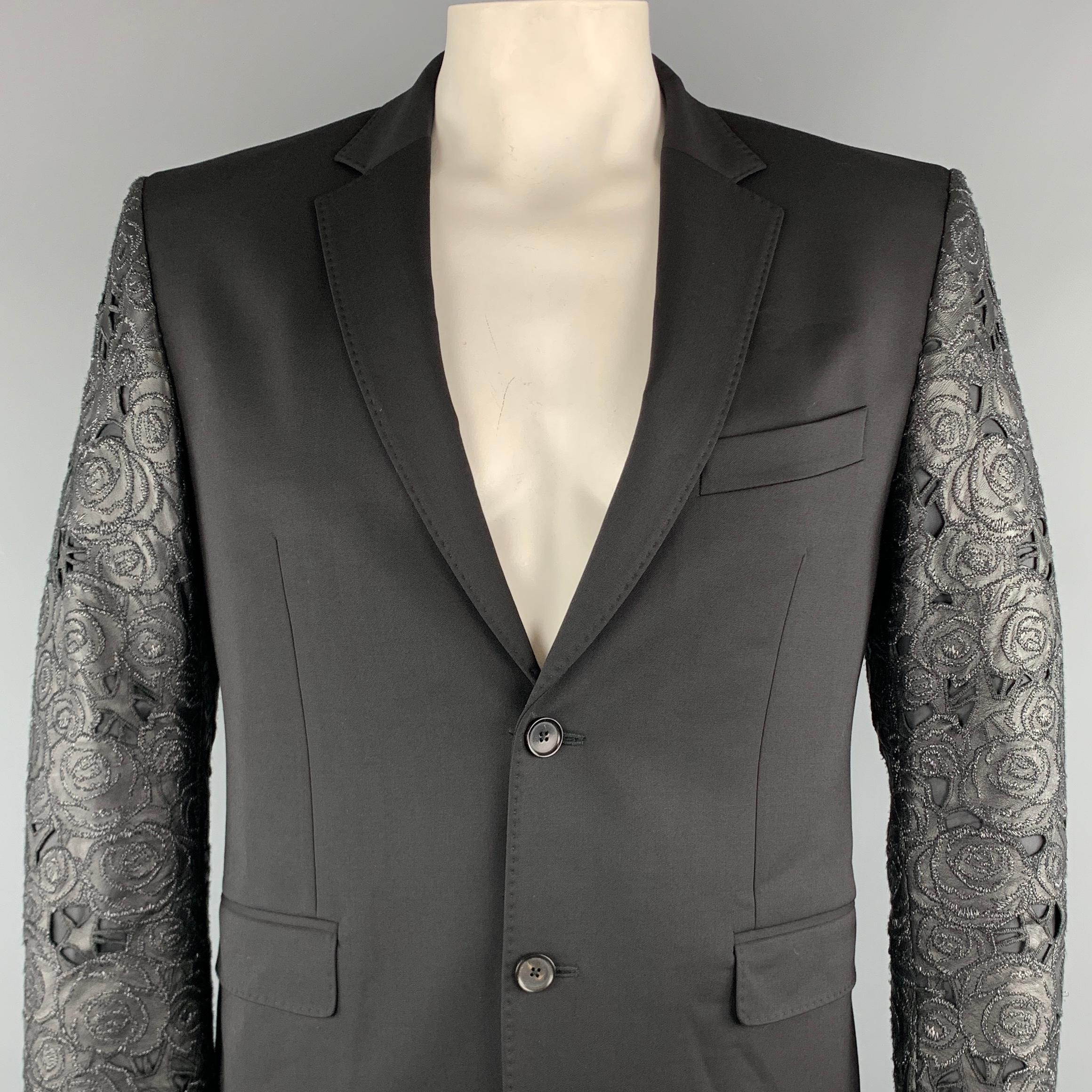 JOHN RICHMOND Sport Coat comes in a black mixed material featuring a notch lapel style, leather lace sleeves, and a two button closure. Made in Italy.

Excellent Pre-Owned Condition.
Marked: 52

Measurements:

Shoulder: 18 in.
Chest: 42 in. 
Sleeve: