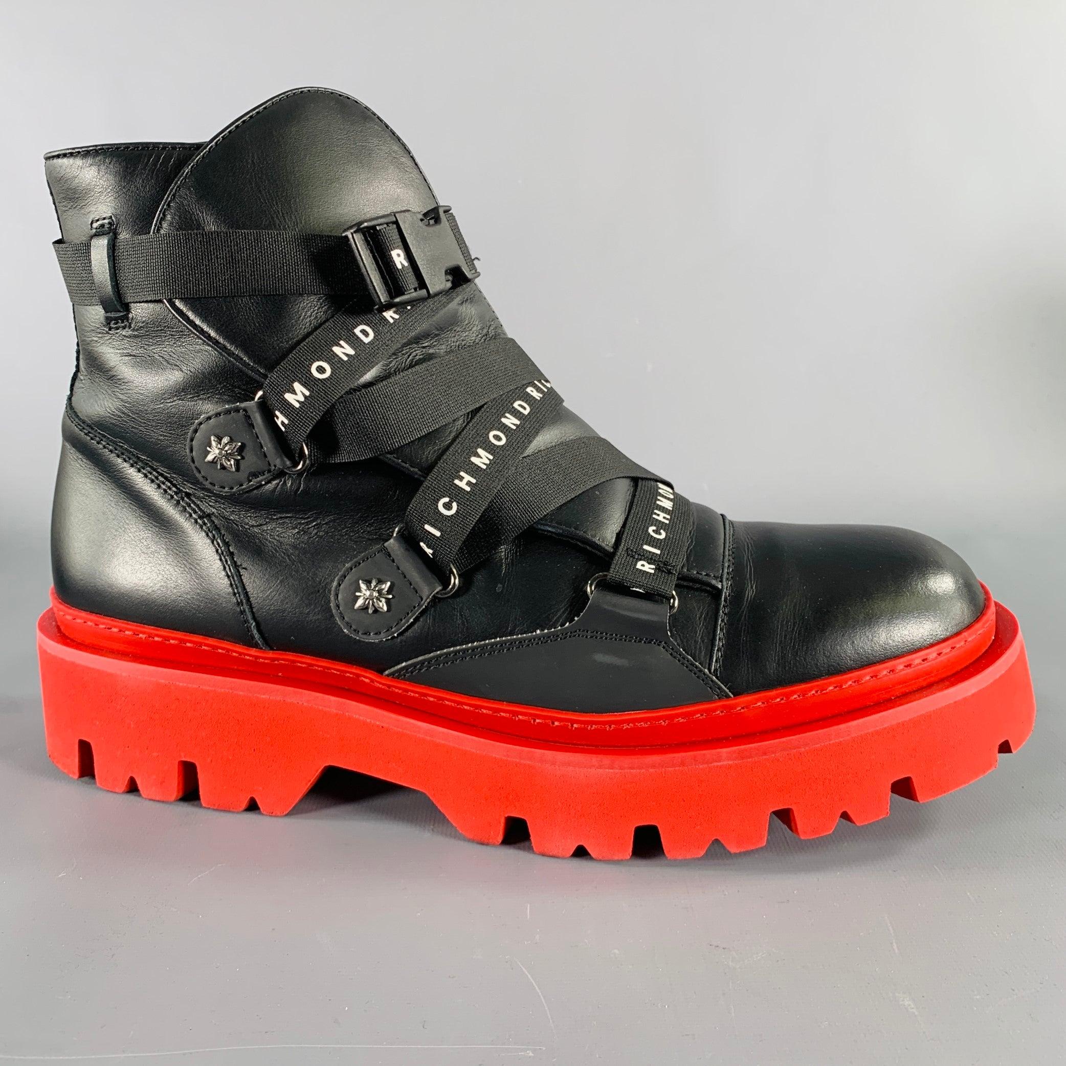 JOHN RICHMOND boots
in a black leather fabric featuring red rubber track sole, straps with white logo, and buckle clasp closure. Comes with box. Made in Italy.New With Box. 

Marked:   EU 46 

Measurements: 
  Length: 12.5 inches Width: 4.75 inches
