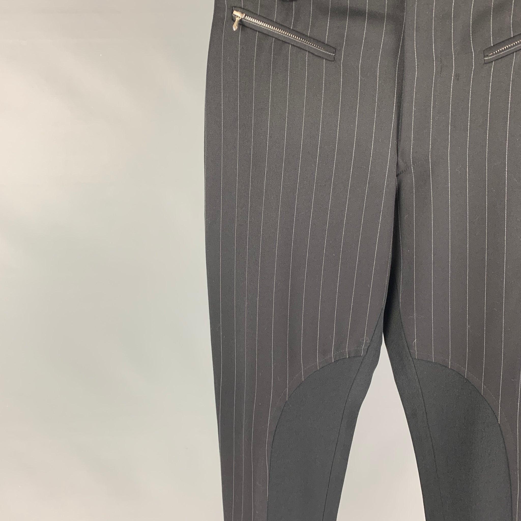 JOHN RICHMOND dress pants comes in a black stripe nylon blend featuring a skinny fit, inseam panel, zipper pockets, and a zip fly closure. Made in England.
Excellent
Pre-Owned Condition. 

Marked:   M  

Measurements: 
  Waist: 31 inches Rise: 12