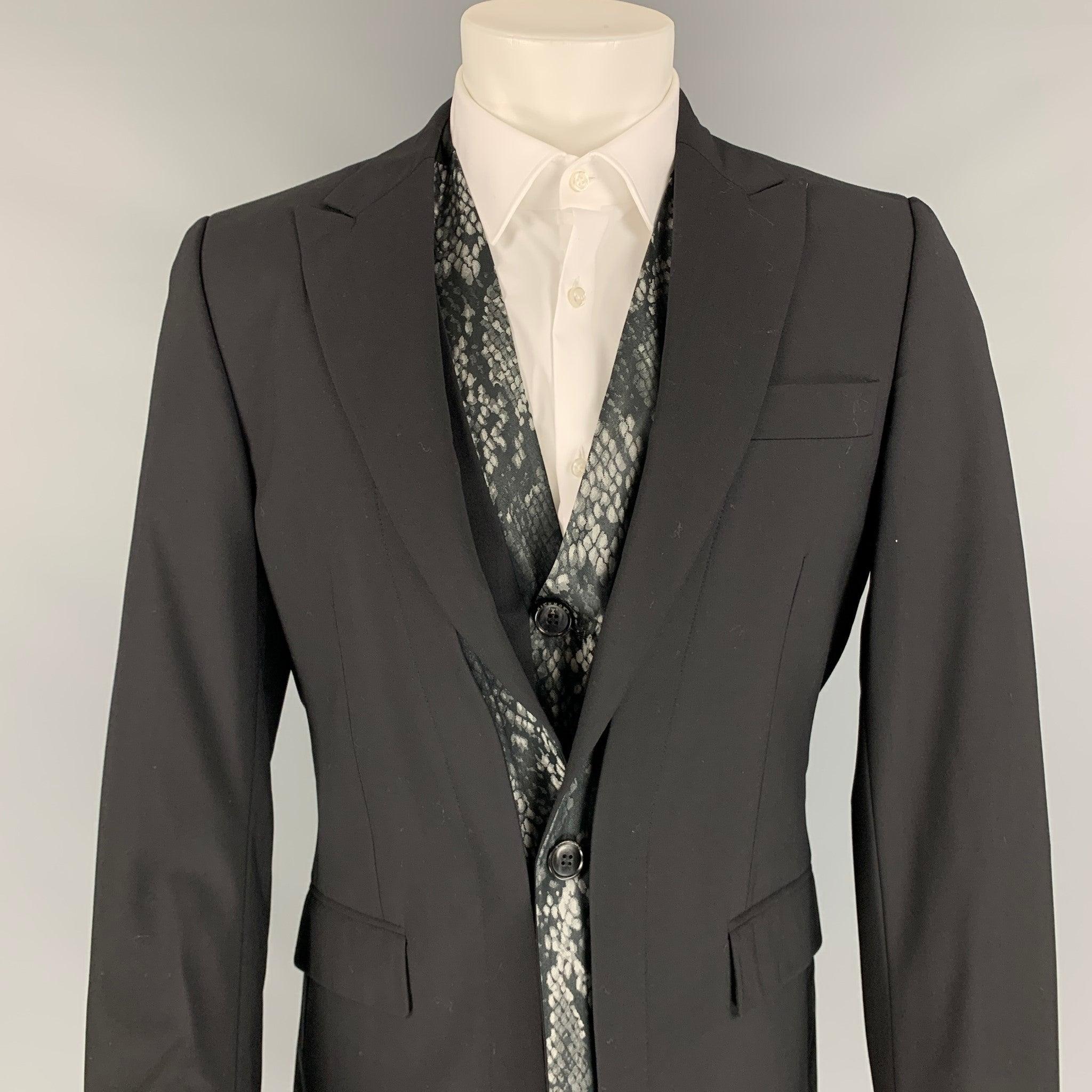 JOHN RICHMOND 2 Piece sport coat comes in a black wool with a full liner featuring a peak lapel, flap pockets, single button closure, and a matching vest. Made in Italy.
Very Good
Pre-Owned Condition. 

Marked:   48 

Measurements: 
 
Shoulder: 17