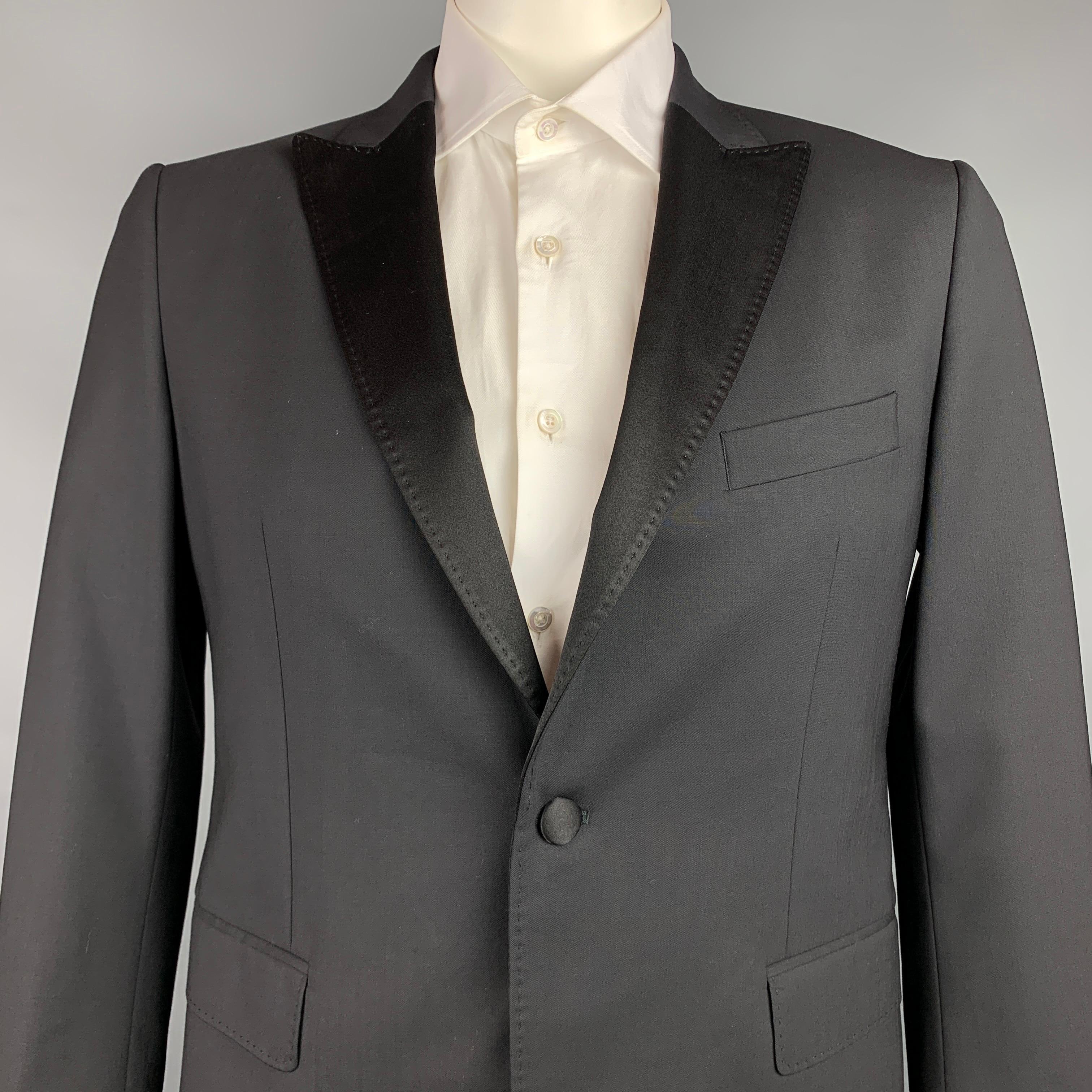 JOHN RICHMOND sport coat comes in a black wool with a full liner featuring a peak lapel, flap pockets, beaded back design, and a single button closure. Made in USA.

Very Good Pre-Owned Condition.
Marked: 52

Measurements:

Shoulder: 18 in.
Chest: