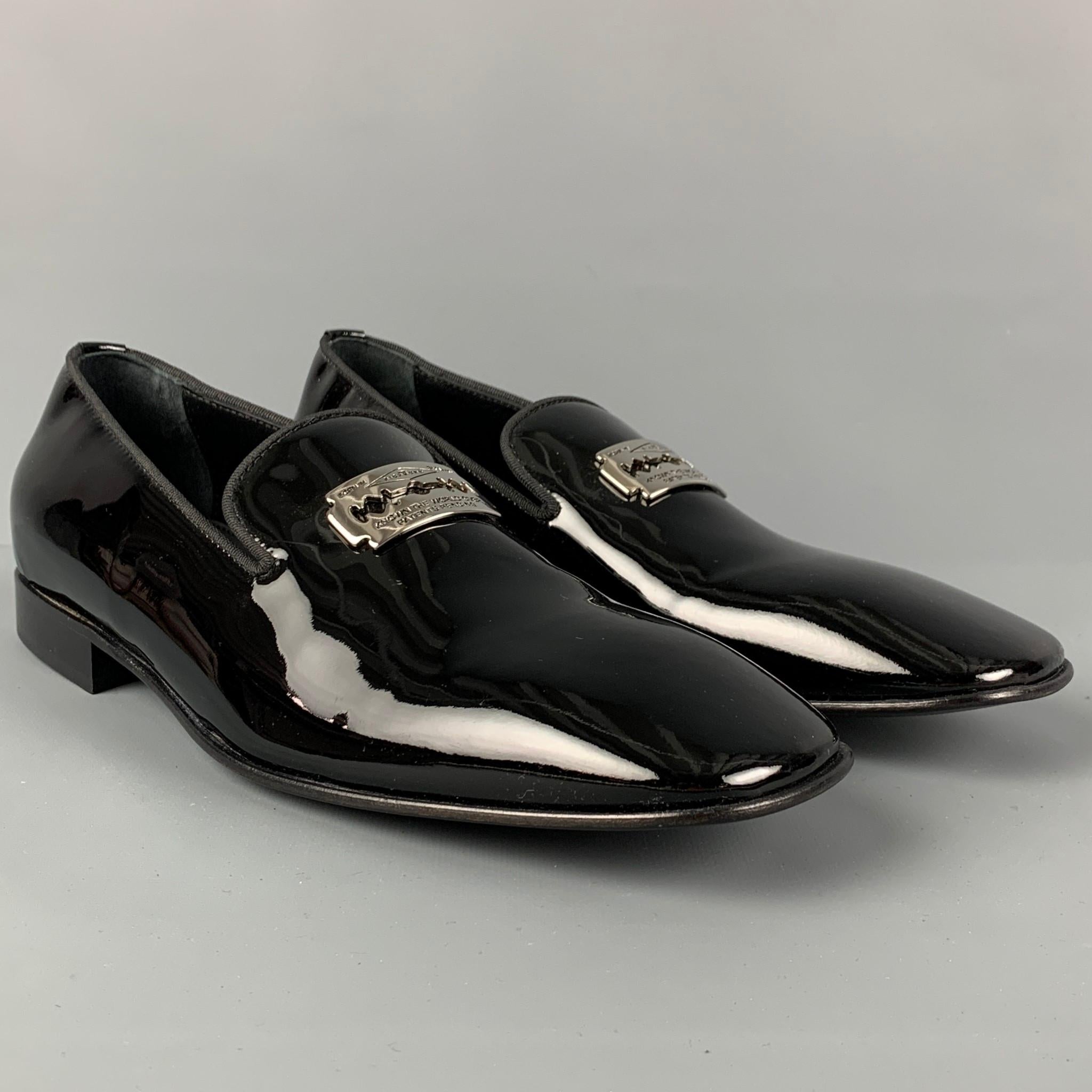 JOHN RICHMOND loafers comes in a black patent leather featuring a silver tone razor blade detail, slip on, square toe, and includes a match belt. Made in Italy.

Very Good Pre-Owned Condition.
Marked: 42.5

Outsole: 12 in. x 4 in. 

-Belt

Very Good