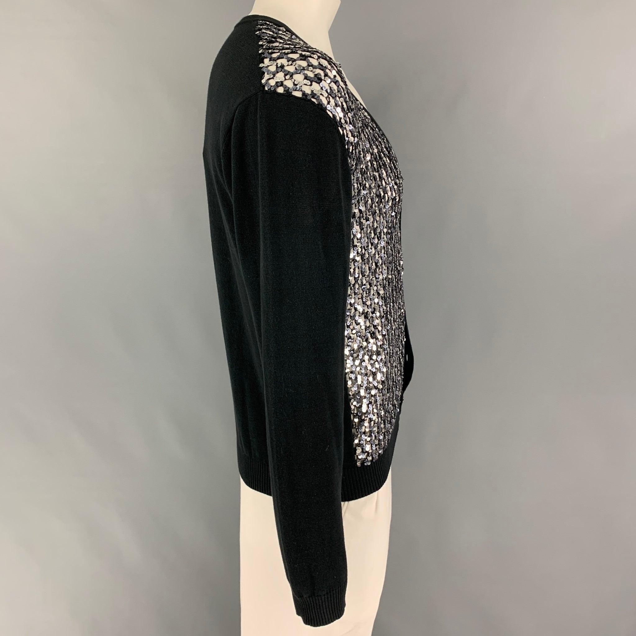 JOHN RICHMOND cardigan comes in a black & silver sequined cotton / PVC featuring a knitted see through design and a buttoned closure. Made in Italy. New with tags.
 

Marked:   54 

Measurements: 
 
Shoulder: 19.5 inches Chest: 44 inches Sleeve: