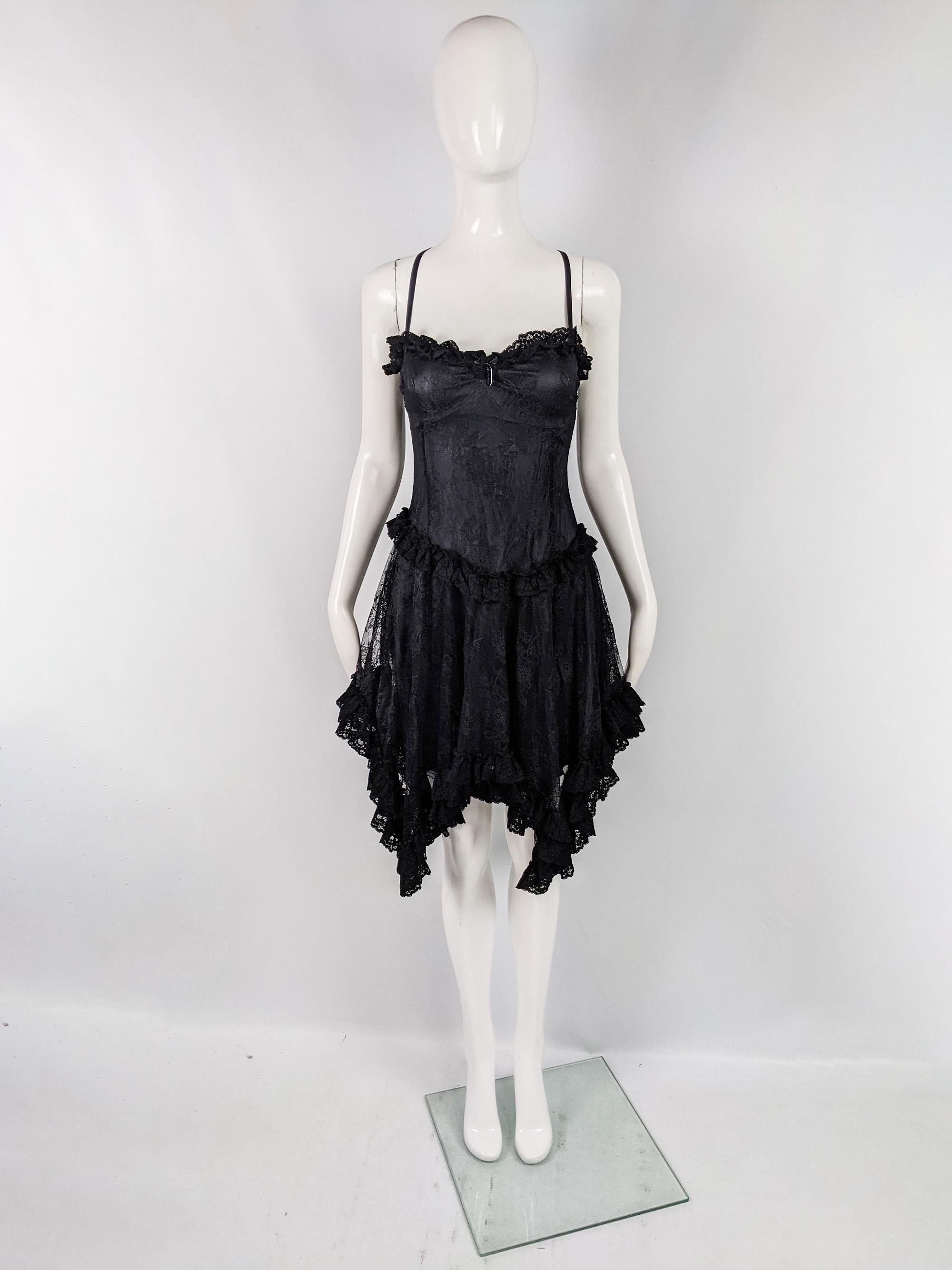 A stunning vintage party dress from the early 2000s by luxury British fashion designer, John Richmond. In a black gothic / vampy lace and silk fabric with a flirty handkerchief hem. 

Size: Marked IT 44 but measures more like a modern UK 8-10/ US