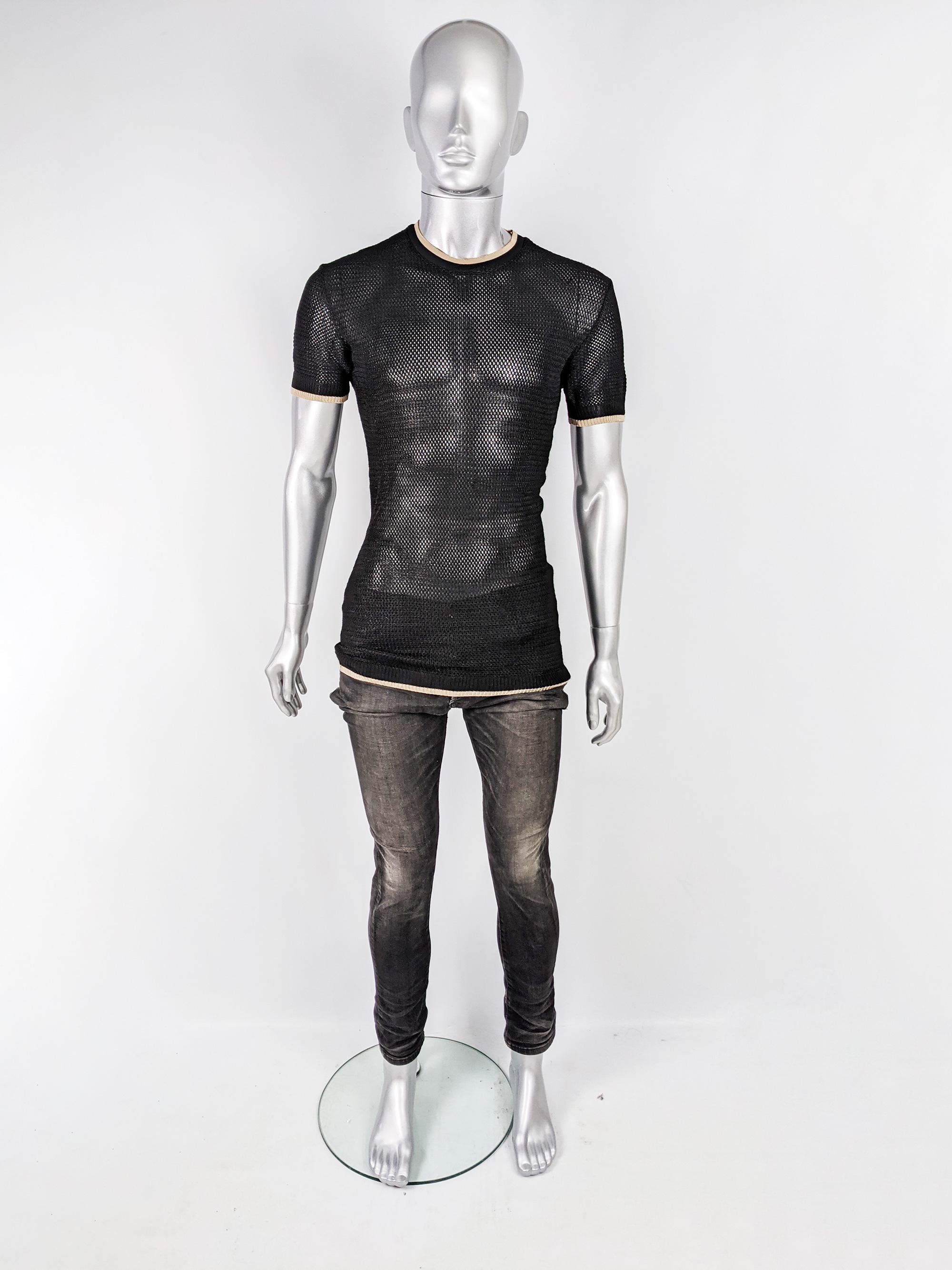 A rare and edgy vintage mens top from the 90s by iconic British fashion designer, John Richmond, for his cult status 'Destroy' label. In a black knit mesh fabric with short sleeves, a crew neck and ribbed trim. 

Size: Marked L but fits more like a