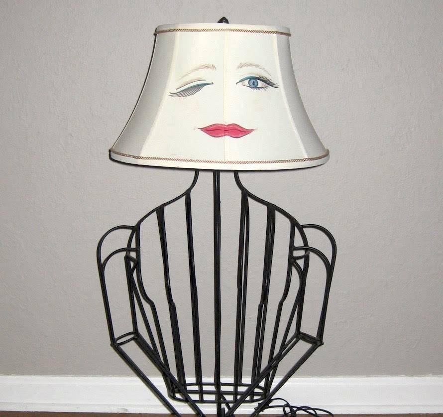 Set of John Risley welded black steel metal rod sculptural lamps in the shape of a curvy woman, circa 1960s, these lamps come with hand-painted face shades, which adds to their whimsy. These iconic, rare lamps are highly sought after in Mid-Century