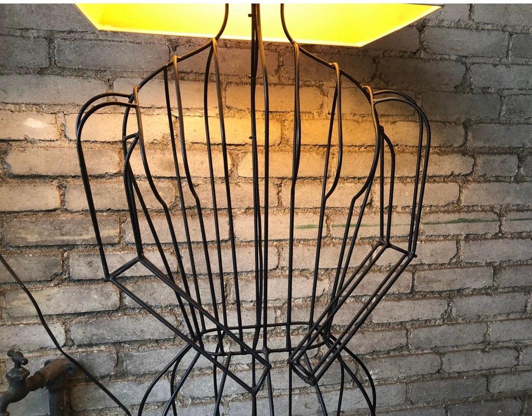 Sixties sculptural mannequin lady figure lamp by John Risley. Enameled wrought iron is in great condition.
The intricate geometrical shape captures the essence of Risley's work. The lampshade has some wear as well as a small crack.

Wired for USA