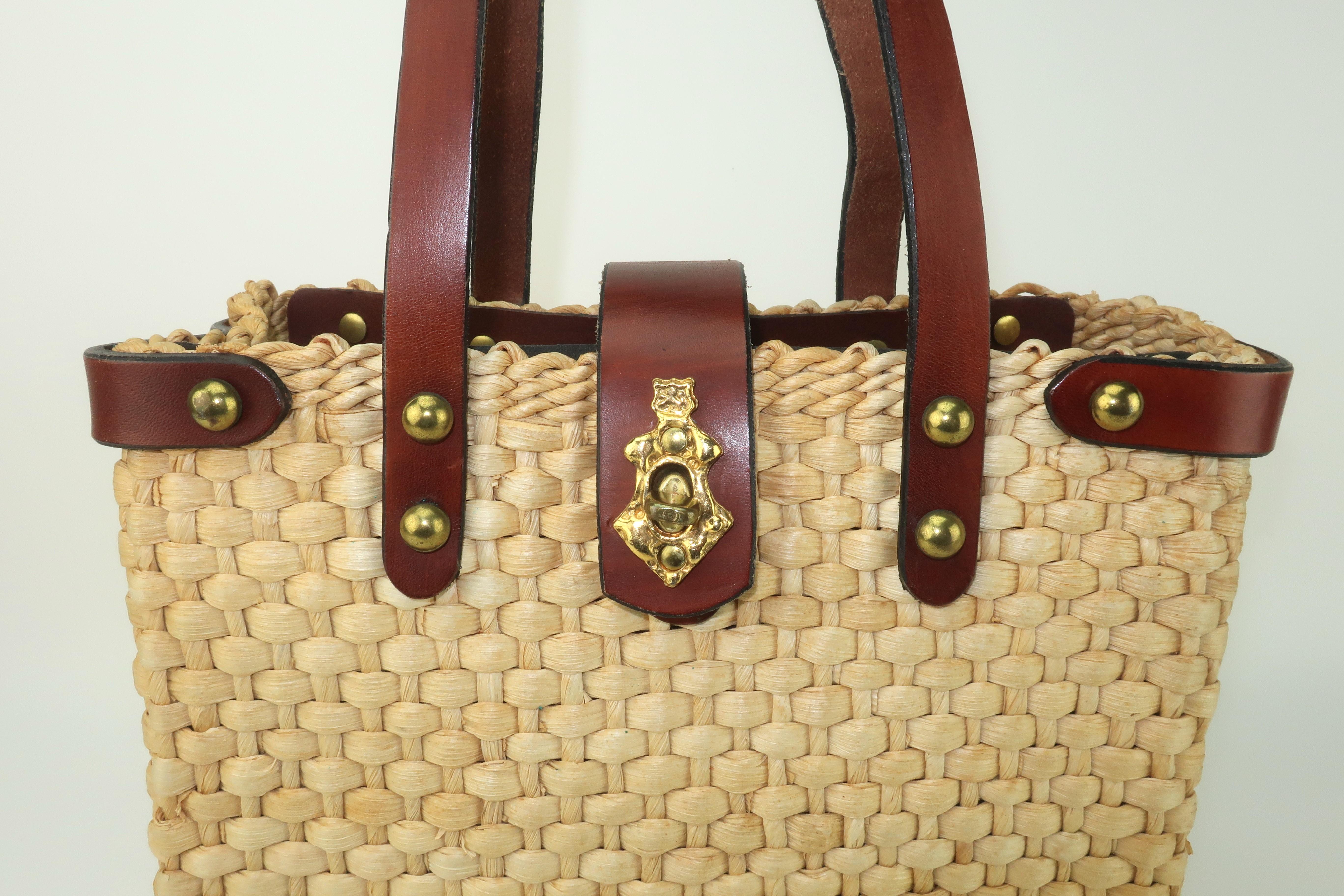 John Romain handbags are an American classic.  In the 1960's and 1970's, the iconic tweed and leather designs were on the arms of preppy coeds from coast to coast.  This straw tote handbag was designed as part of a late 1960's collection to
