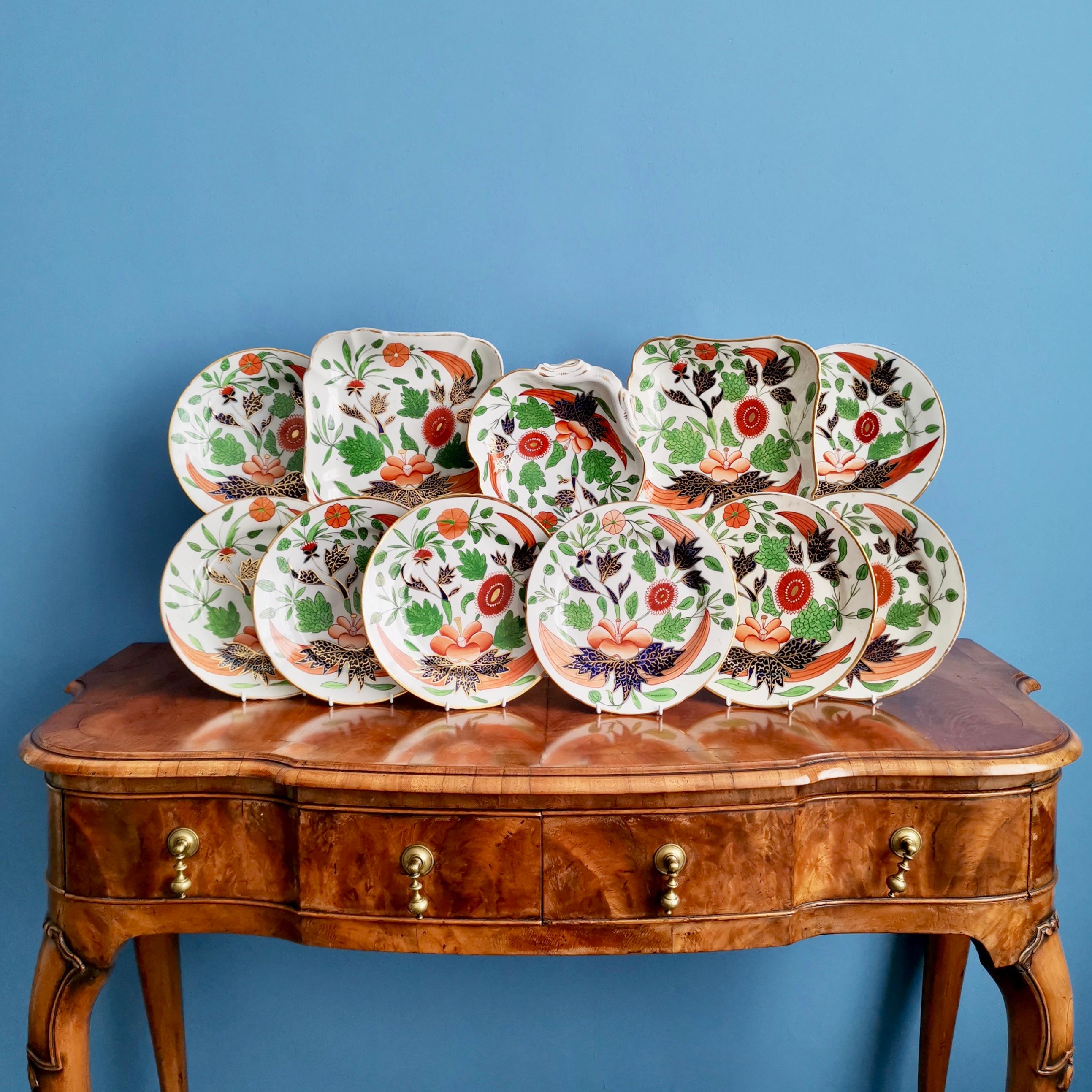 This is a very boldly decorated John Rose / Coalport dessert service made in about 1805, which is known as the Georgian period. The service is decorated in a very bold Imari pattern and consists of eight plates, two square dishes and one shell