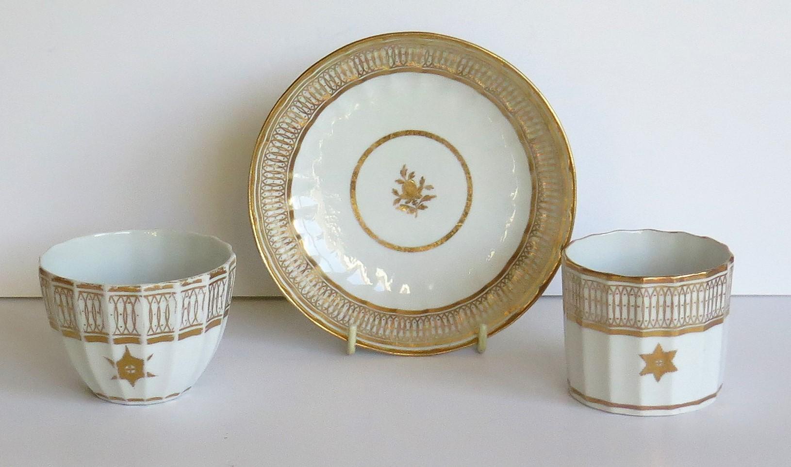 This is an early porcelain trio comprising a coffee can, tea cup and saucer, all in gilded patterns, which we attribute to Coalport, John Rose & Co., Shropshire, England, made at the turn of the 18th century, George 111rd period, circa 1800.

All