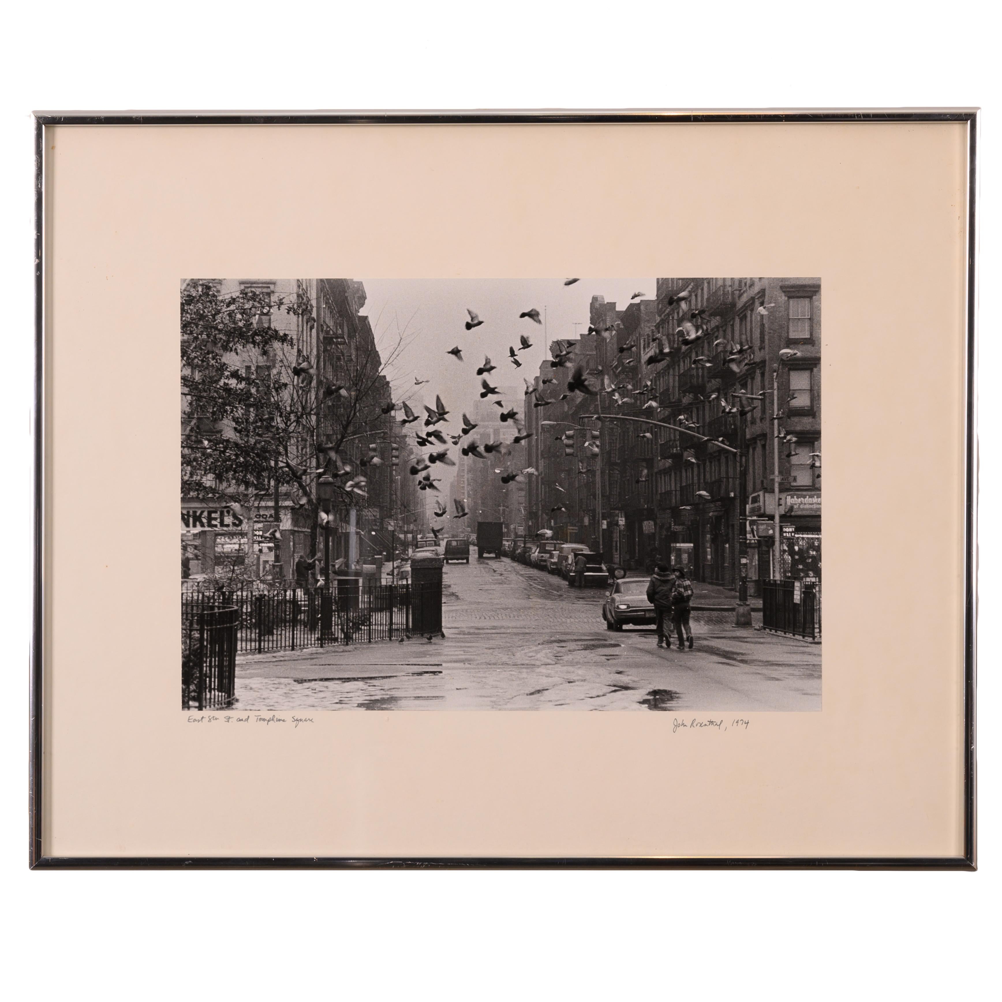 John Rosenthal
(American, b. 1942)

A silver gelatin photograph capturing a street scene from New York City’s East Village in the 1970’s.

titled: East 8th St. and Tompkins Square

signed: John Rosenthal, 1974

photo: 13 ¾ by 9 ¼ inches

Frame: 20 ¼