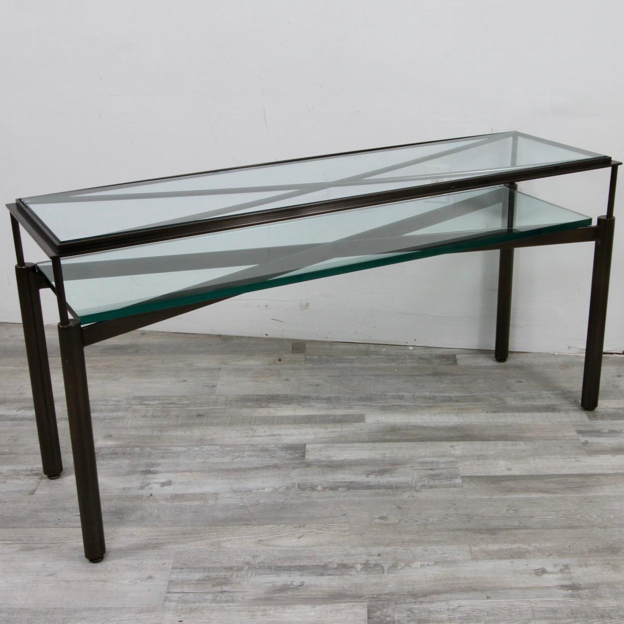 Designed by John Saladino as part of his Facade Collection for Baker, this gunmetal and glass console table is an exceedingly rare find. Rectangular form with inset beveled glass top over sophisticated 