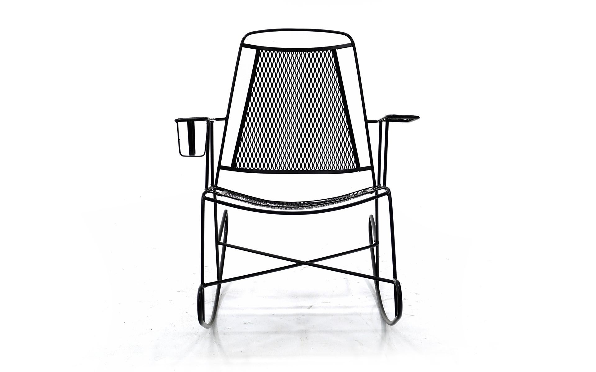 Patio rocker in wrought iron and stamped metal by John Salterini. This has been professionally media blasted and powder coated in a satin black finish. Looks and function like new. Very comfortable, complete with a built in cup / drink holder.