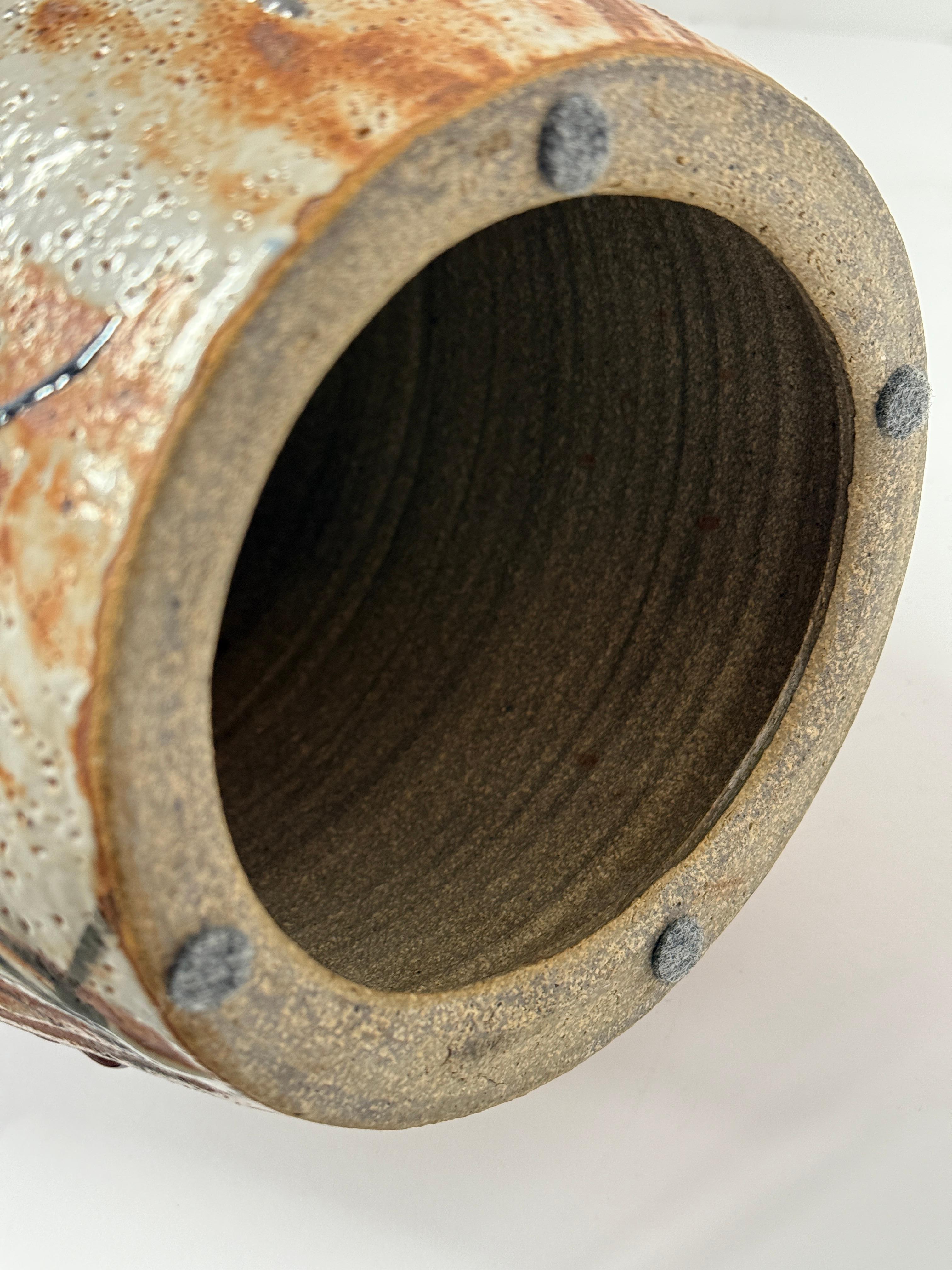 A beautiful pottery lamp by the noted New Jersey Potter John Shedd. This lamp as surrently configured stands 27 inches tall to finial top. The pottery itself is 16 inches tall without the electrical fittings. The pottery is 8 inches in diameter. the