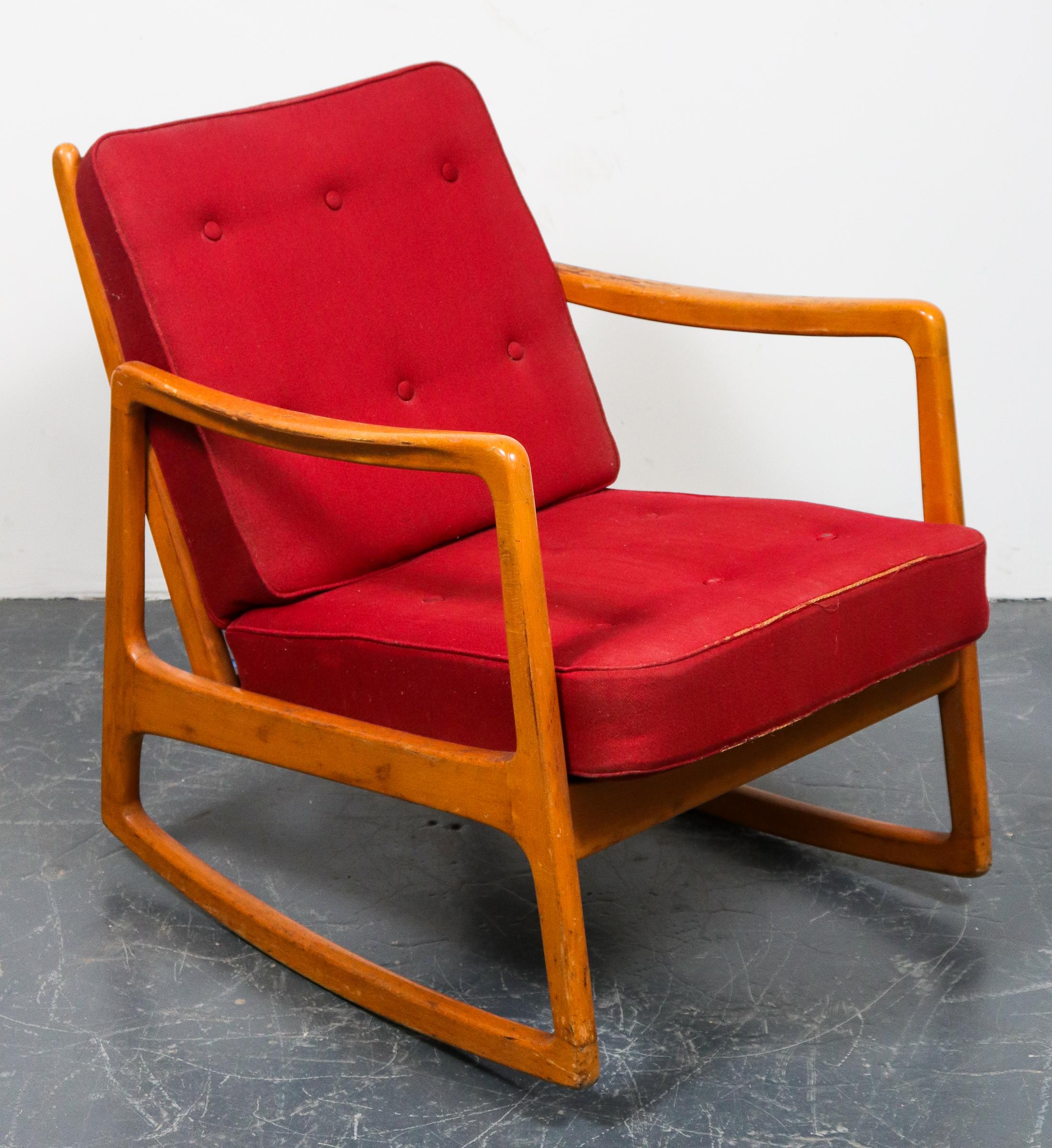 John Stuart American Mid-Century Modern rocking chair, wood frame with red tufted upholstered cushion seat and back, label affixed to frame. Measures: 29.5