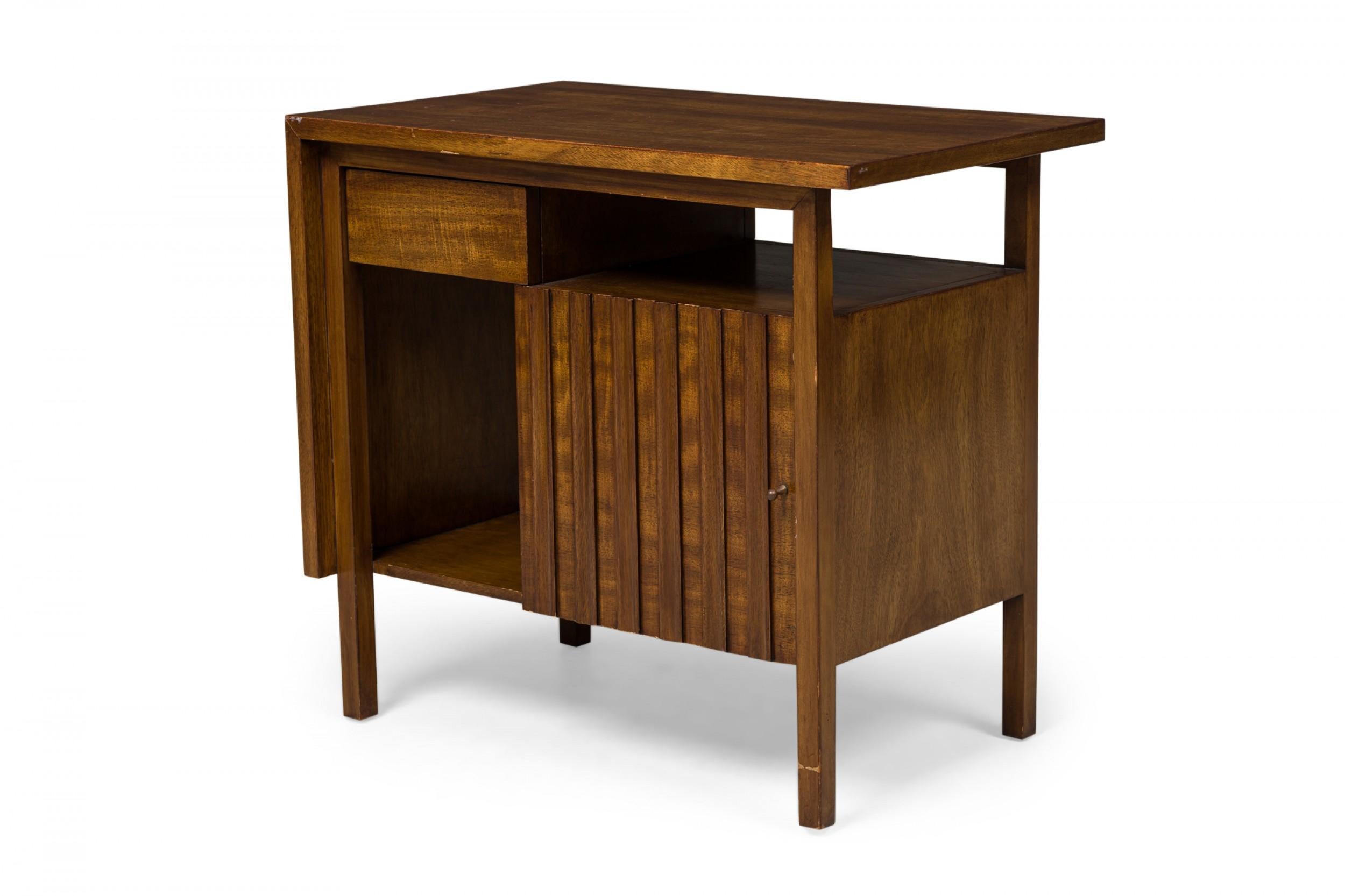 American midcentury walnut bedside table / end table with a single drawer to the left of an open compartment over a mirrored base arrangement comprised of an open cabinet and a larger closed cabinet that opens to the right with a slat front door,