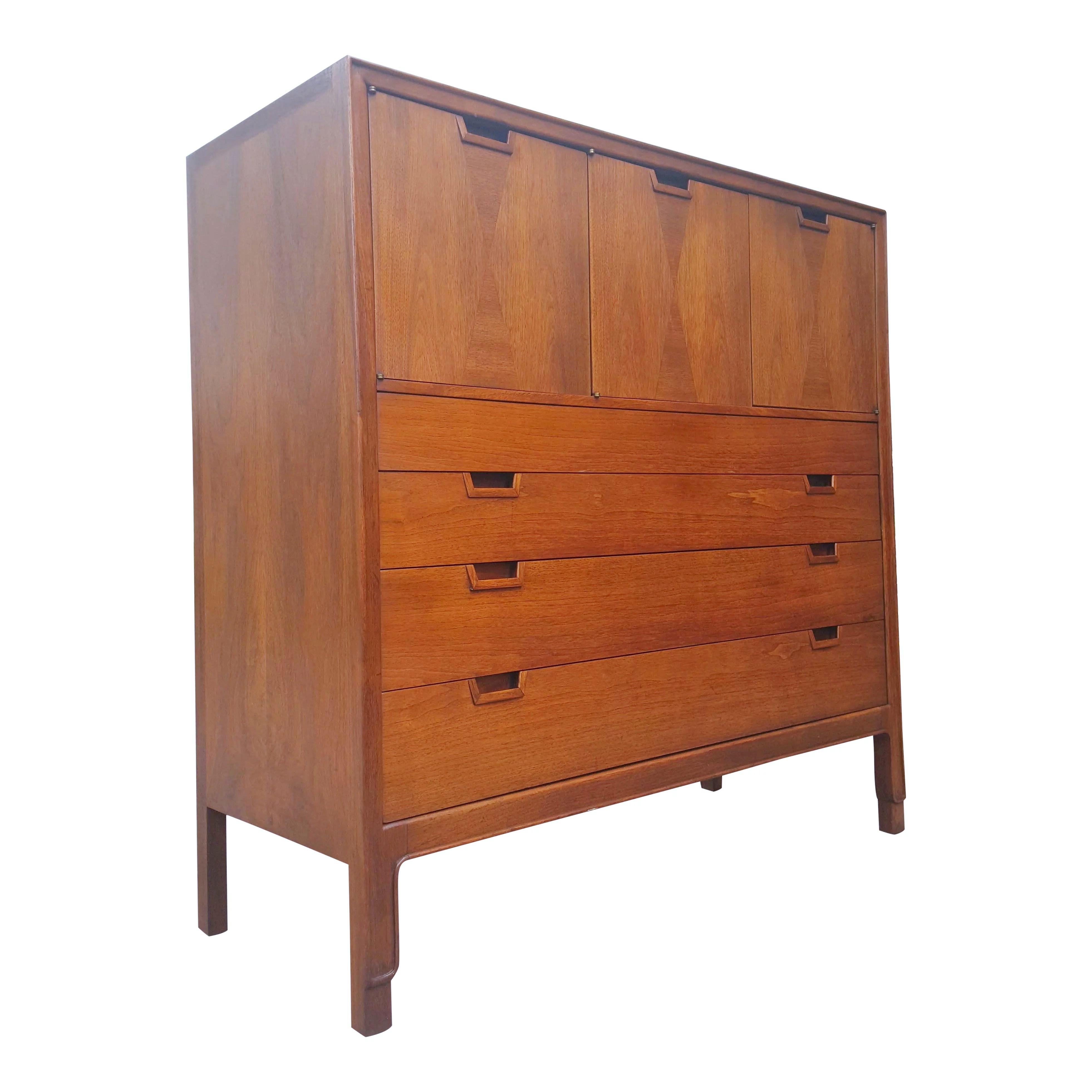 This highboy gentleman's chest by John Stuart for Janus collection is absolutely gorgeous! Classic 1960s design is accented by hourglass shaped alternating veneers. This is a highly sought after and collectible piece. Professionally restored it