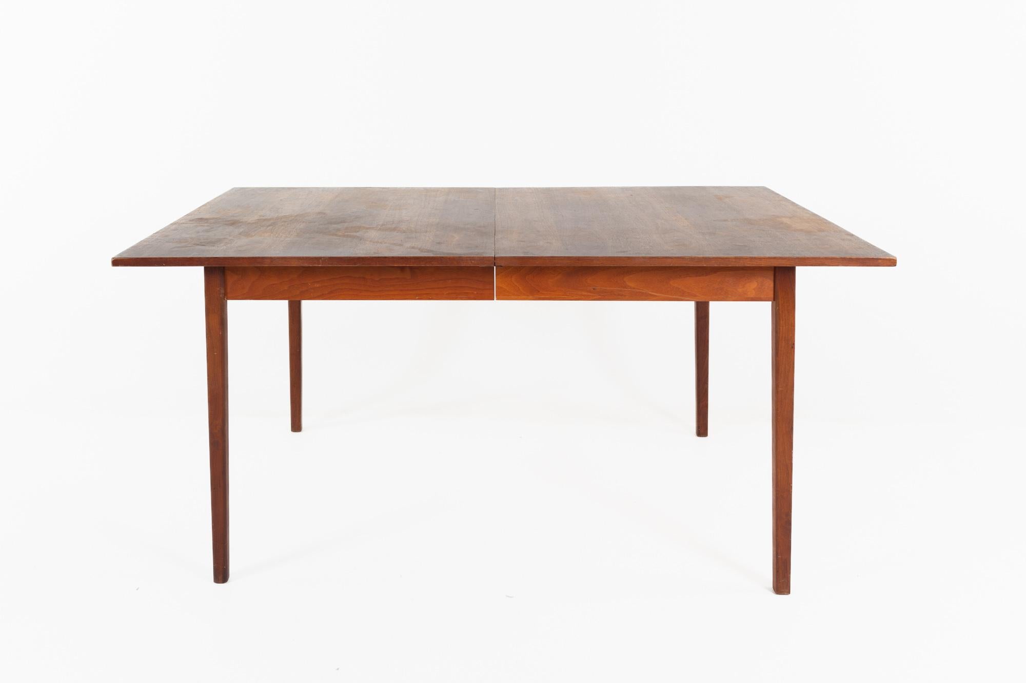 John Stuart for Mount Airy style mid century walnut dining table with leaf

This table measures: 64 wide x 42 deep x 28 inches high, with a chair clearance of 25 inches, the leaf is 20 inches wide, making a maximum table width of 84 inches

All