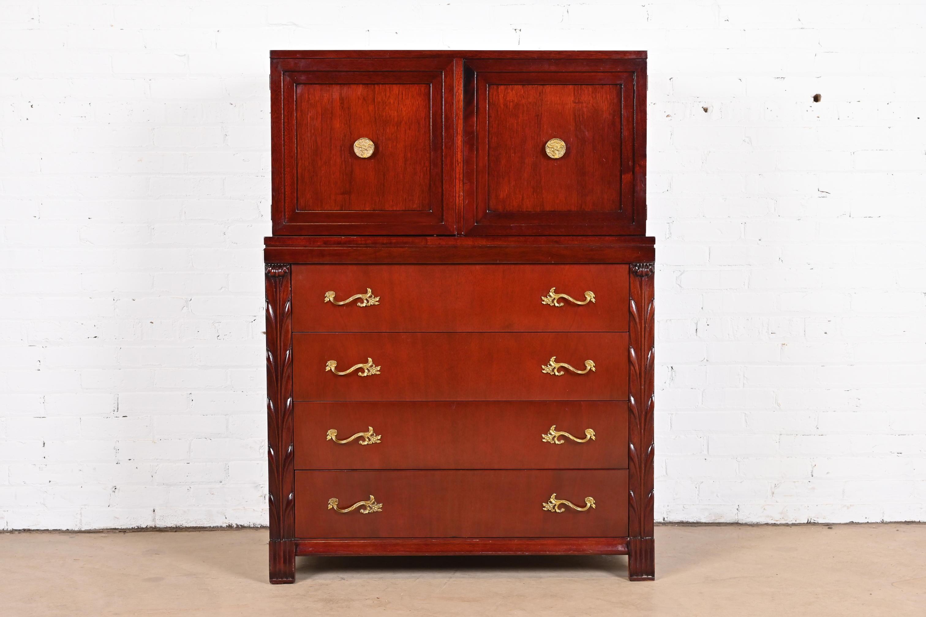 A gorgeous French Regency Louis XVI style highboy dresser or gentleman's chest

By John Stuart

USA, circa 1940s

Carved mahogany, with original brass hardware.

Measures: 38