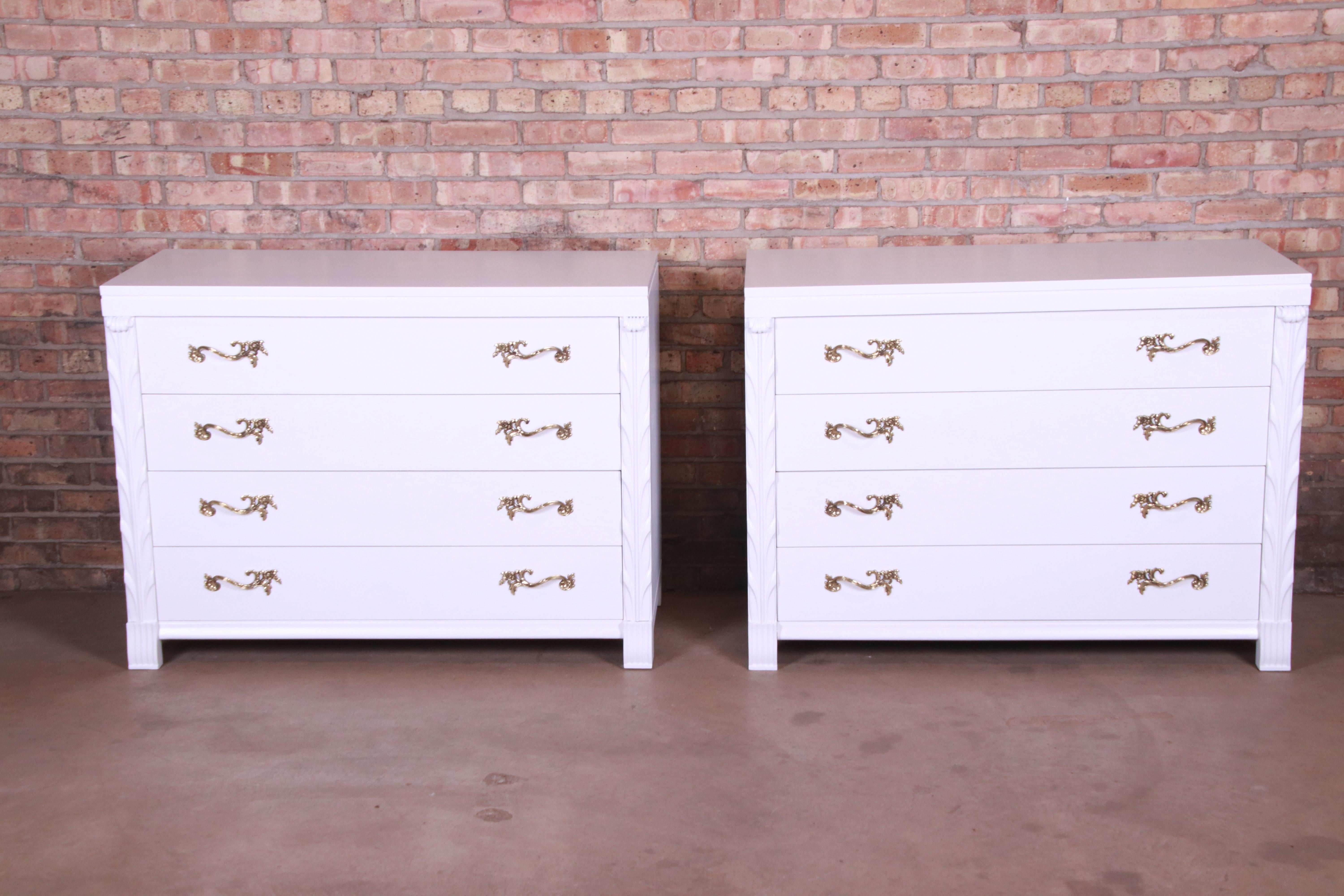 An outstanding pair of midcentury French Regency bachelor chests, commodes, or large bedside chests

By John Stuart

USA, circa 1940s

White lacquered mahogany, with original brass hardware.

Measures: 46