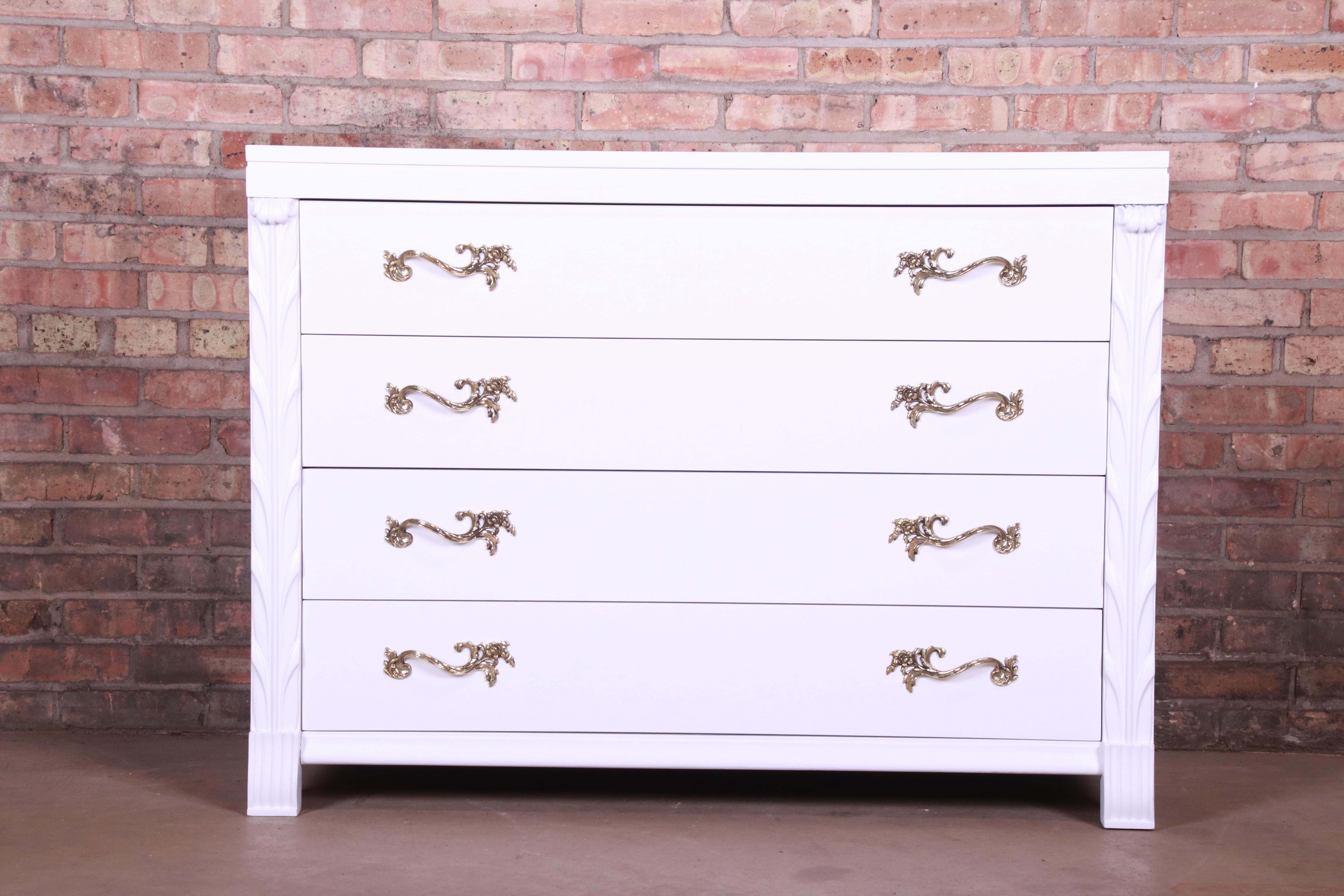 An outstanding midcentury French Regency dresser chest or commode

By John Stuart

USA, circa 1940s

White lacquered mahogany, with original brass hardware.

Measures: 46